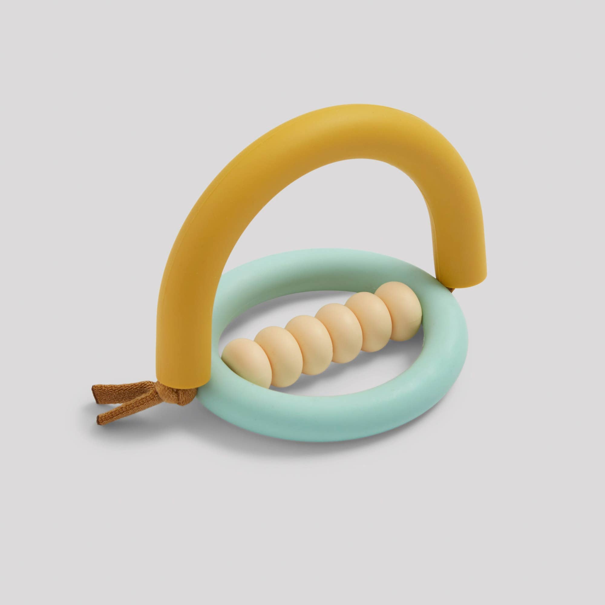A yellow and blue teething ring with beads and a leather string.