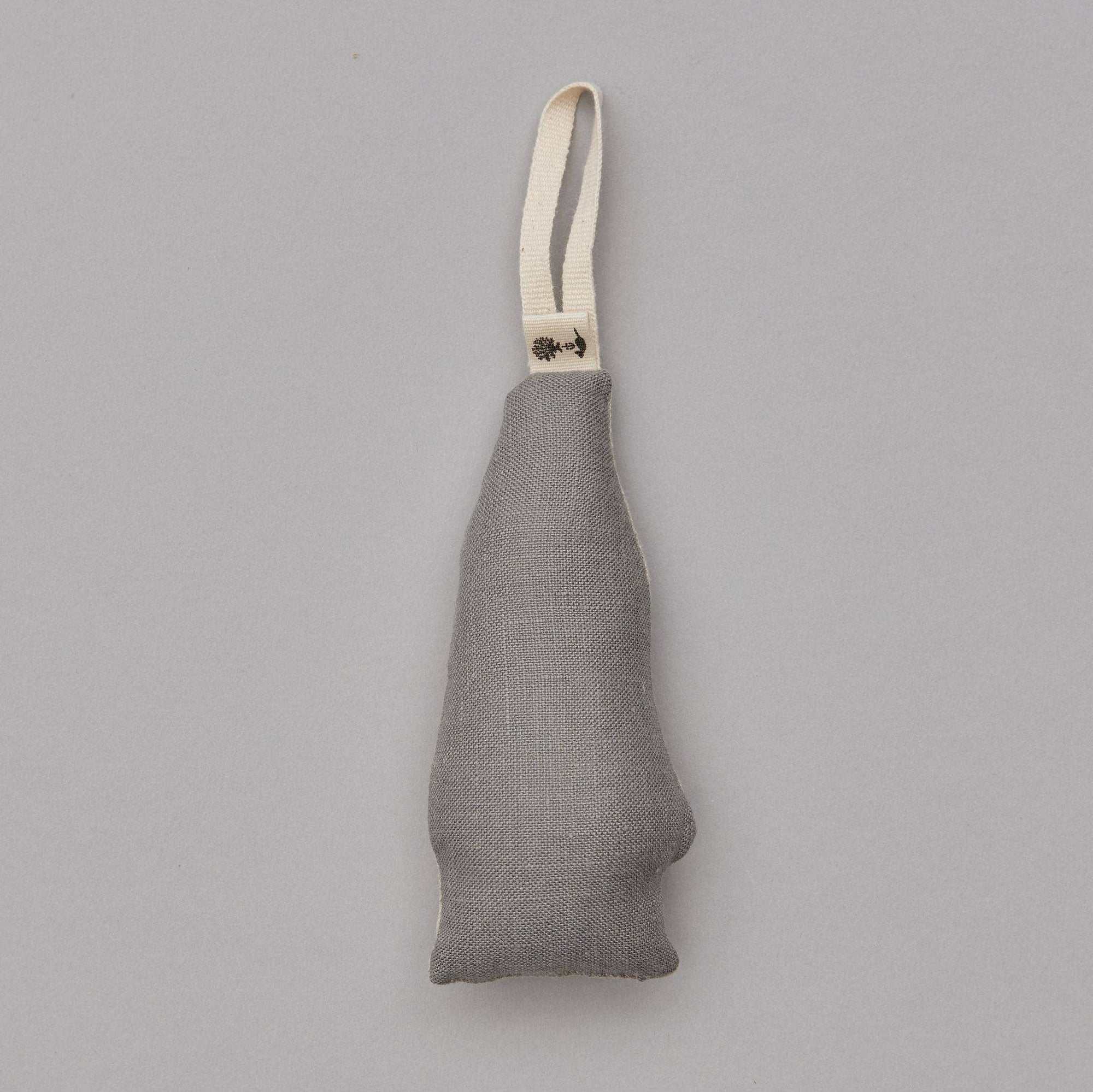 Gray fabric ornament with a strap on a gray background