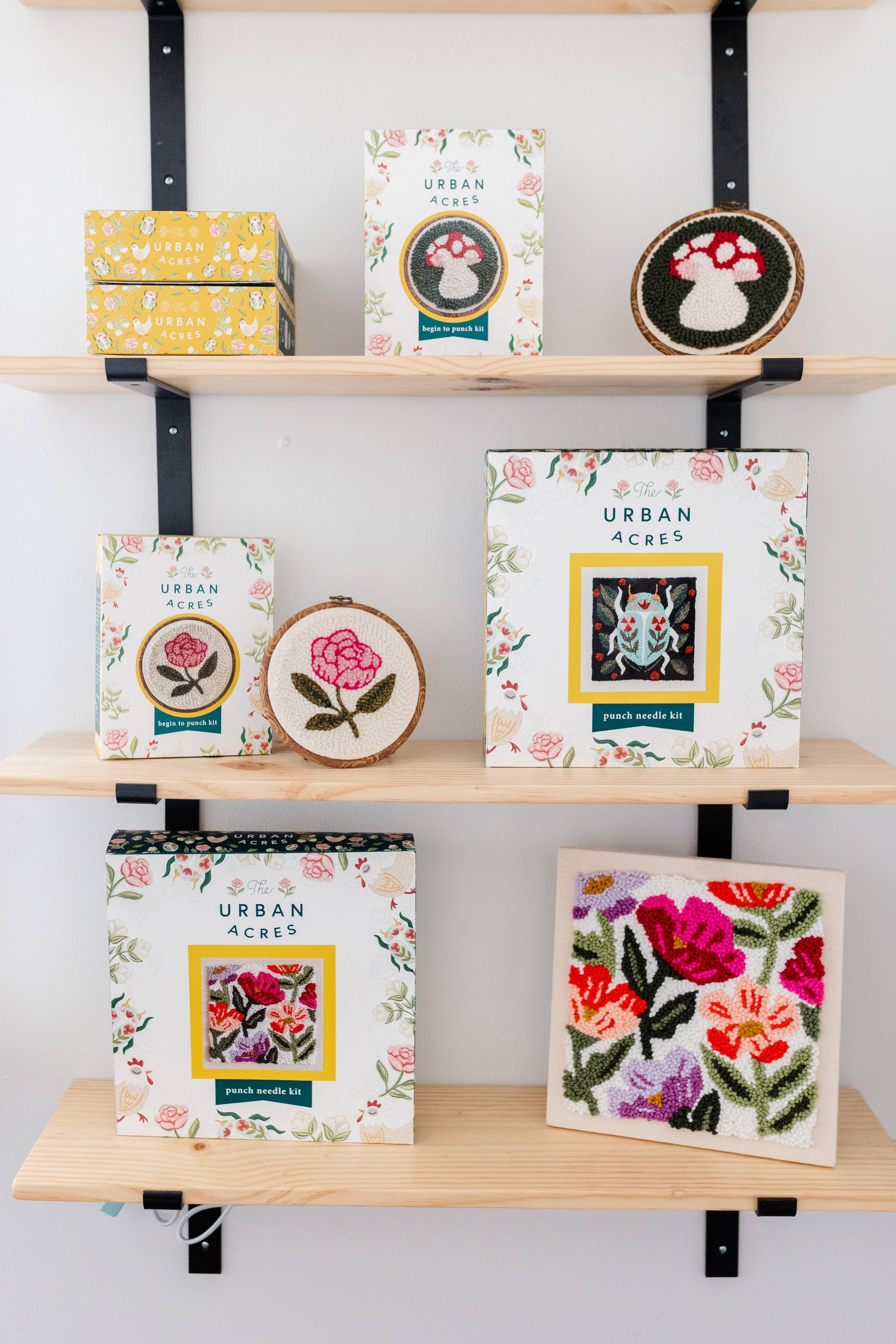 Shelves with decorative boxes and framed artwork labeled 'Urban Acres'.