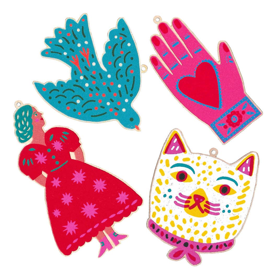Colorful paper cutouts of a dove, hand, woman, and cat on a white background