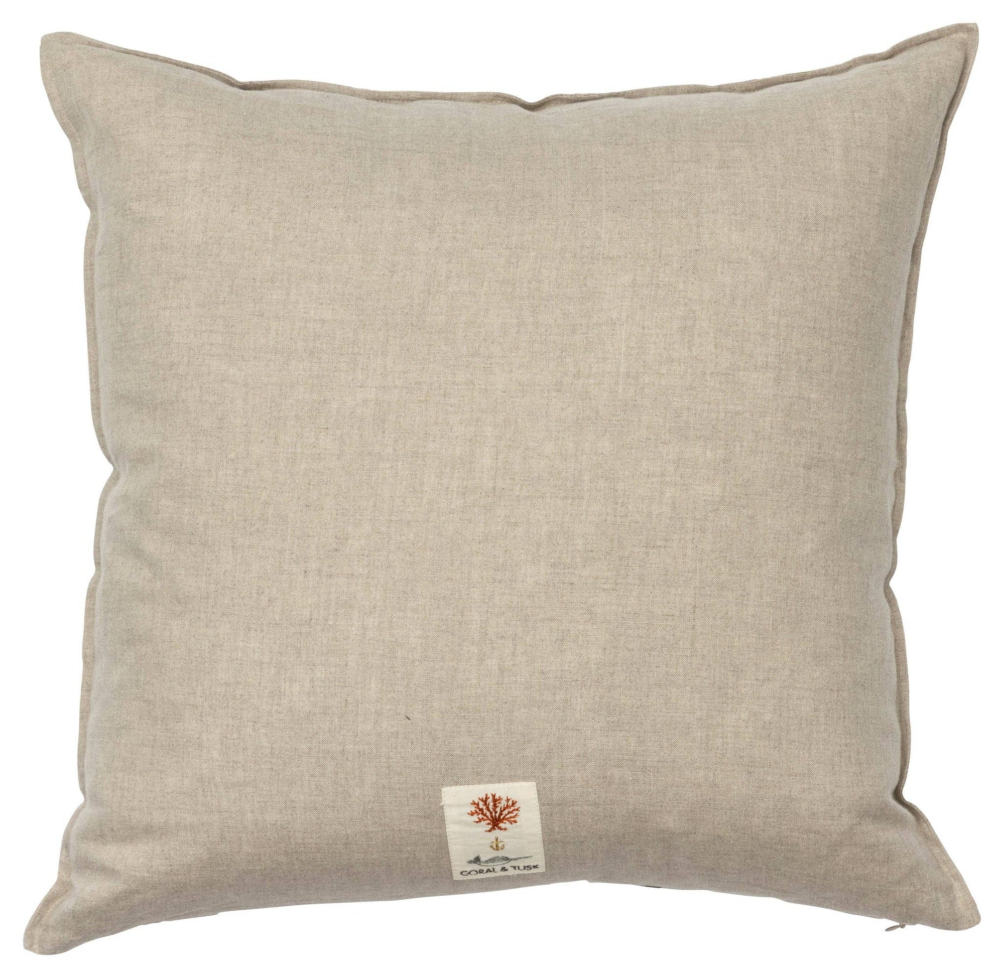 Beige pillow with a small label on a white background