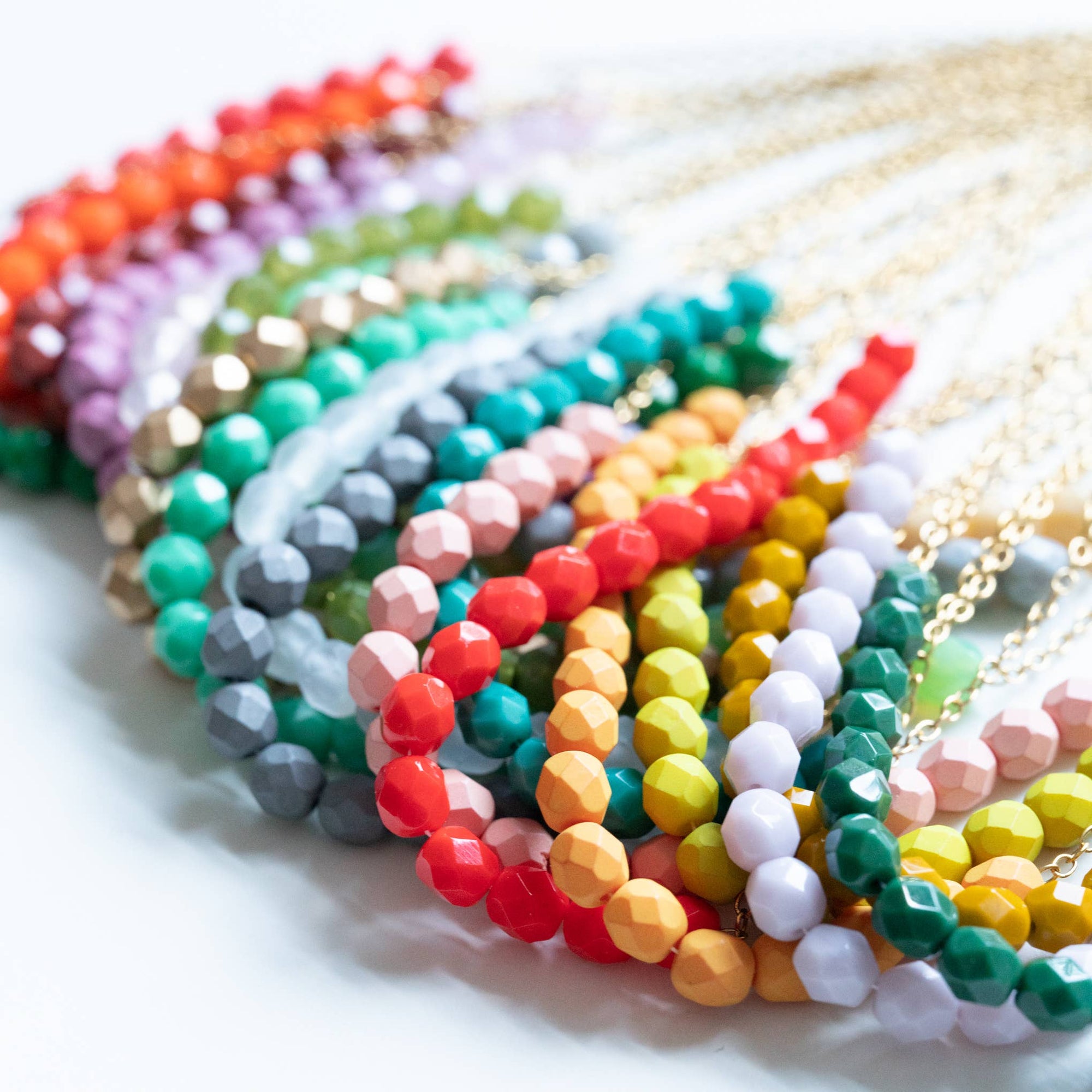 Colorful beaded bracelets on a white surface