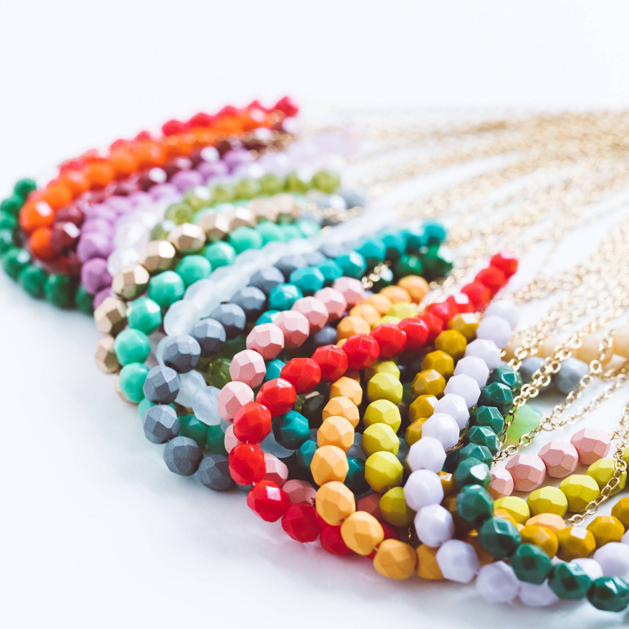 Colorful beaded bracelets on a white surface