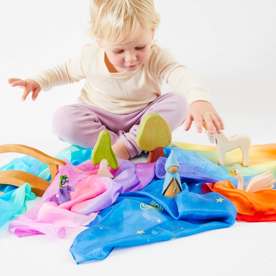 Child playing with colorful toys on a white background