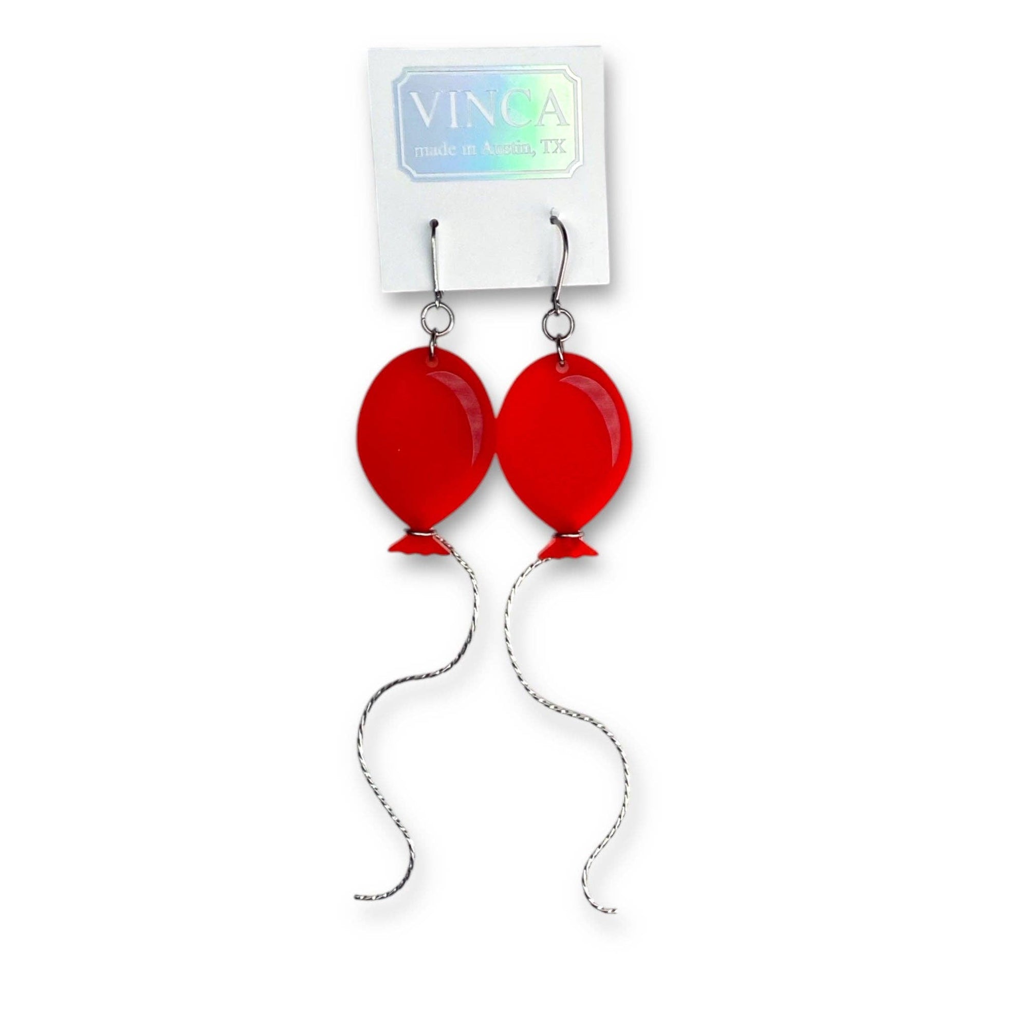 Red balloon-shaped earrings on a white card with 'VINCA' branding.