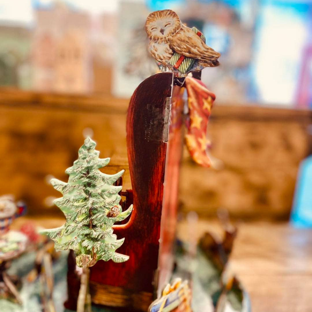 Wooden carving of an owl on a branch with a blurred background