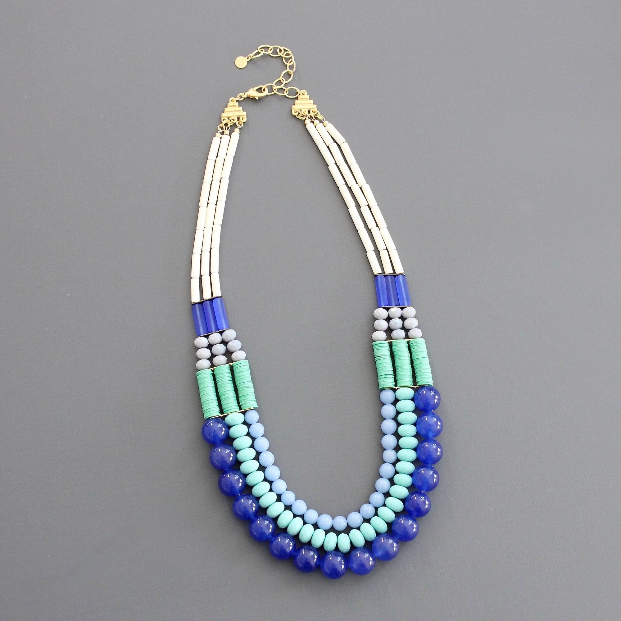 Multicolored beaded necklace on a gray background