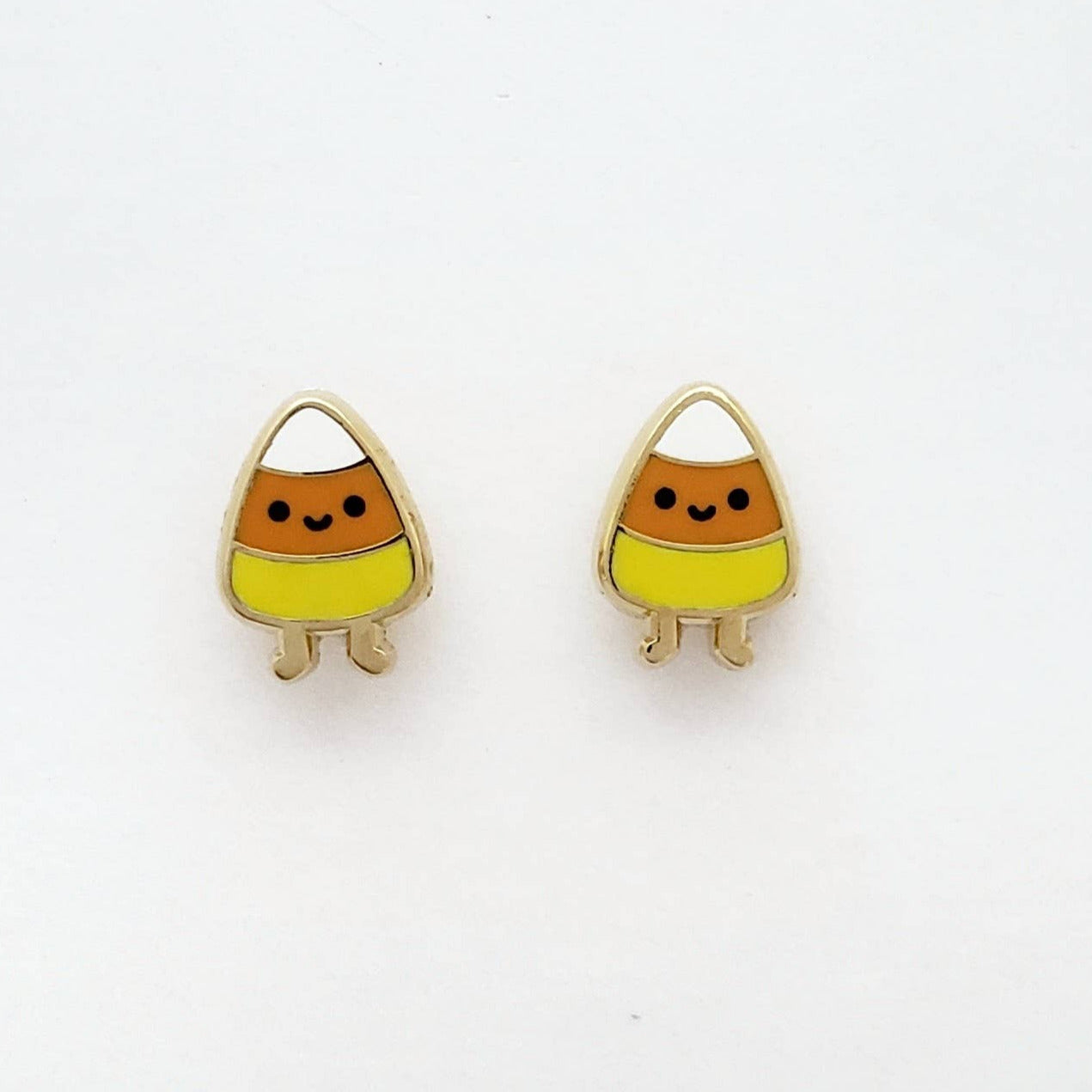 Candy corn-shaped earrings on a white background