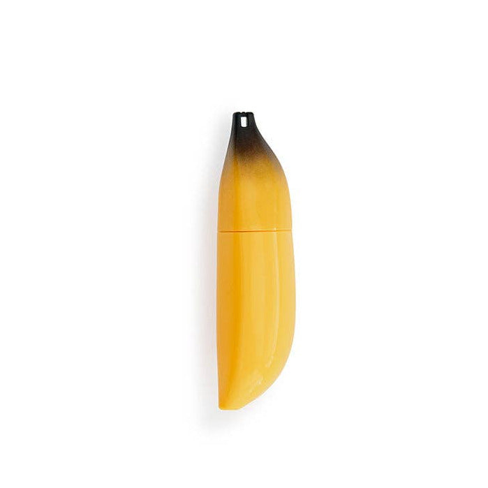 Yellow and black banana lip gloss on a white background