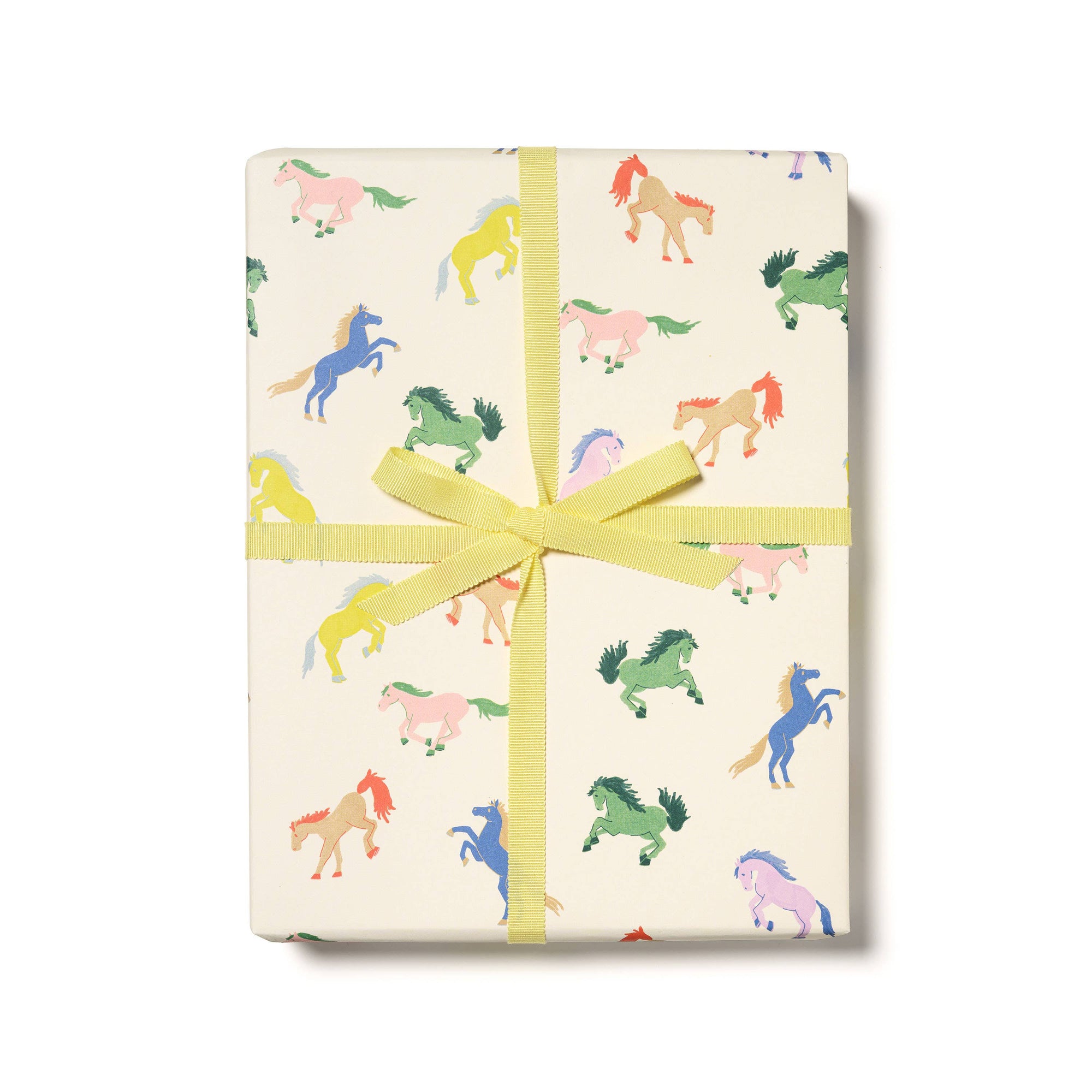 Gift box with colorful horse pattern and yellow ribbon on a white background