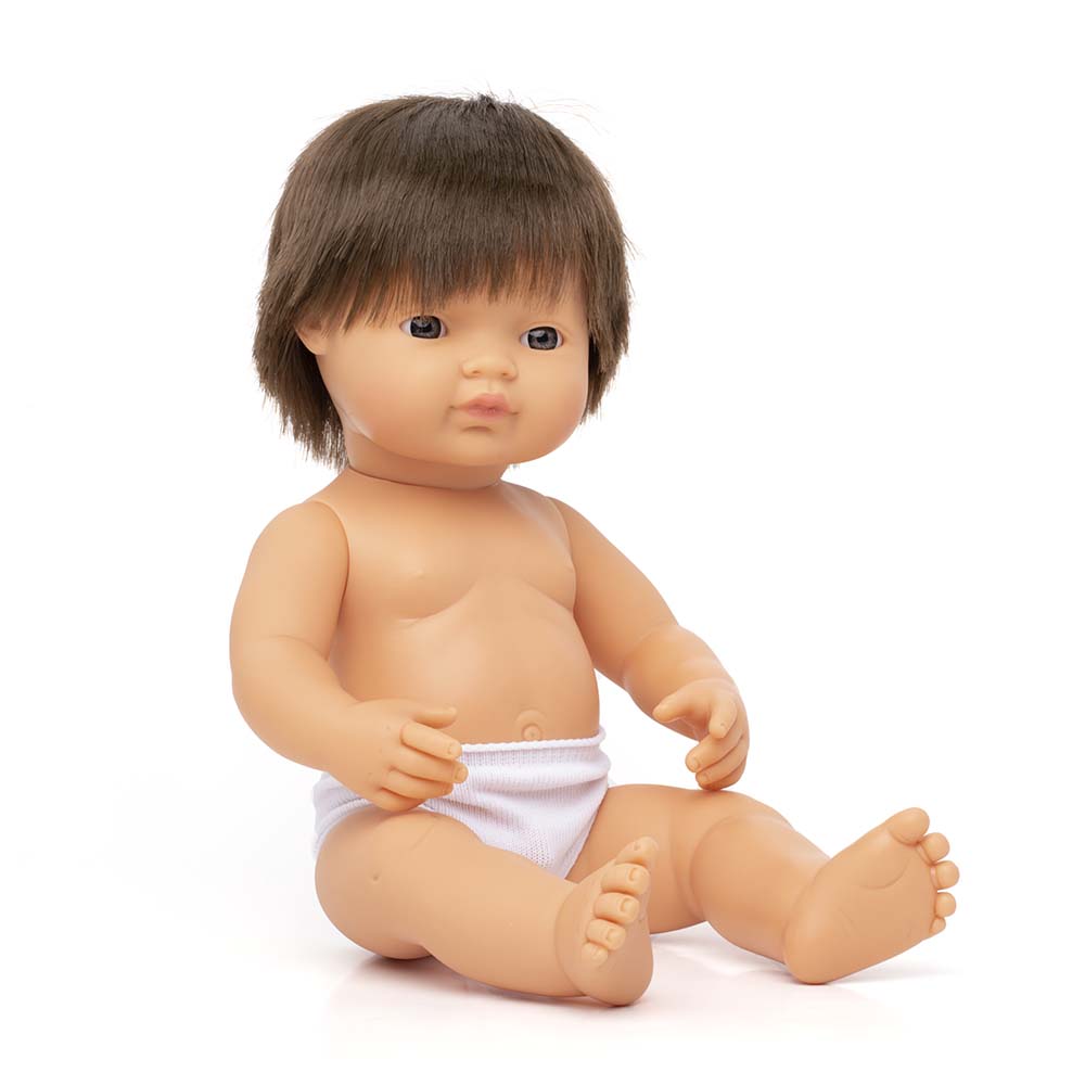 Baby doll with brown hair and a white diaper on a white background