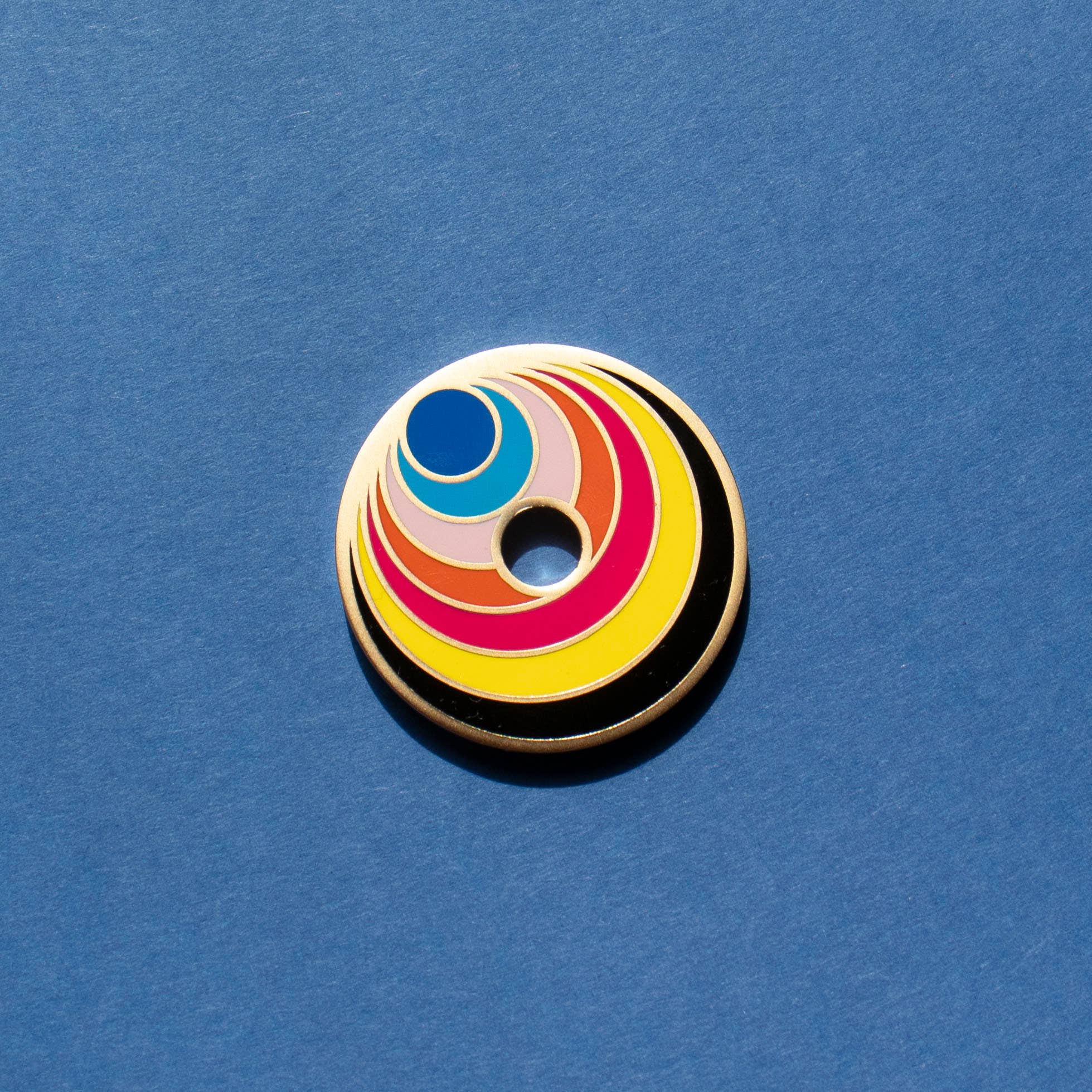 Colorful circular object with concentric rings on a blue background