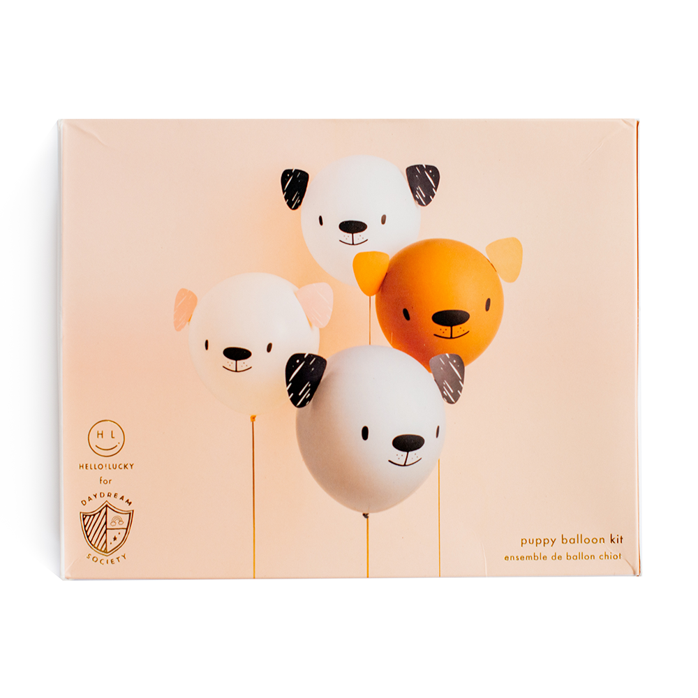 Puppy balloon kit packaging with balloons shaped like dogs on a beige background