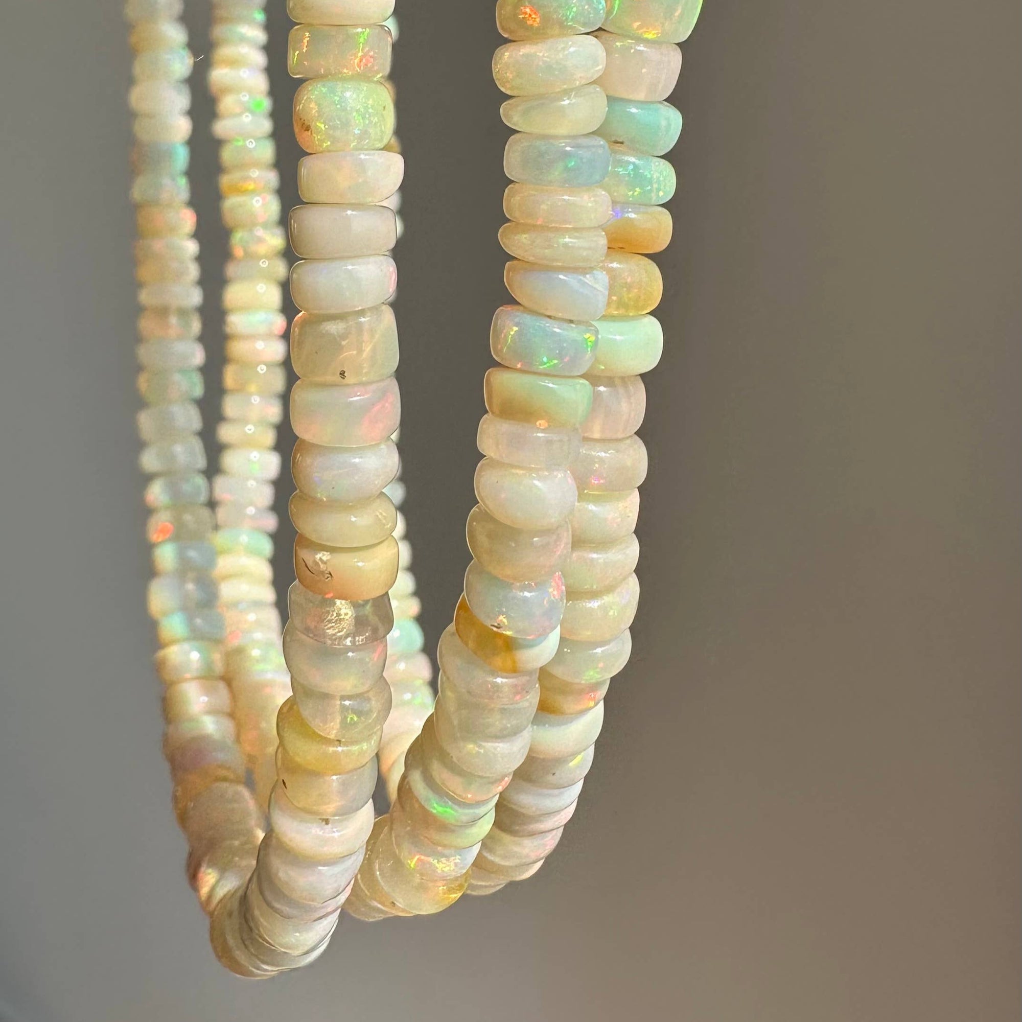 Opal beads on a gray background
