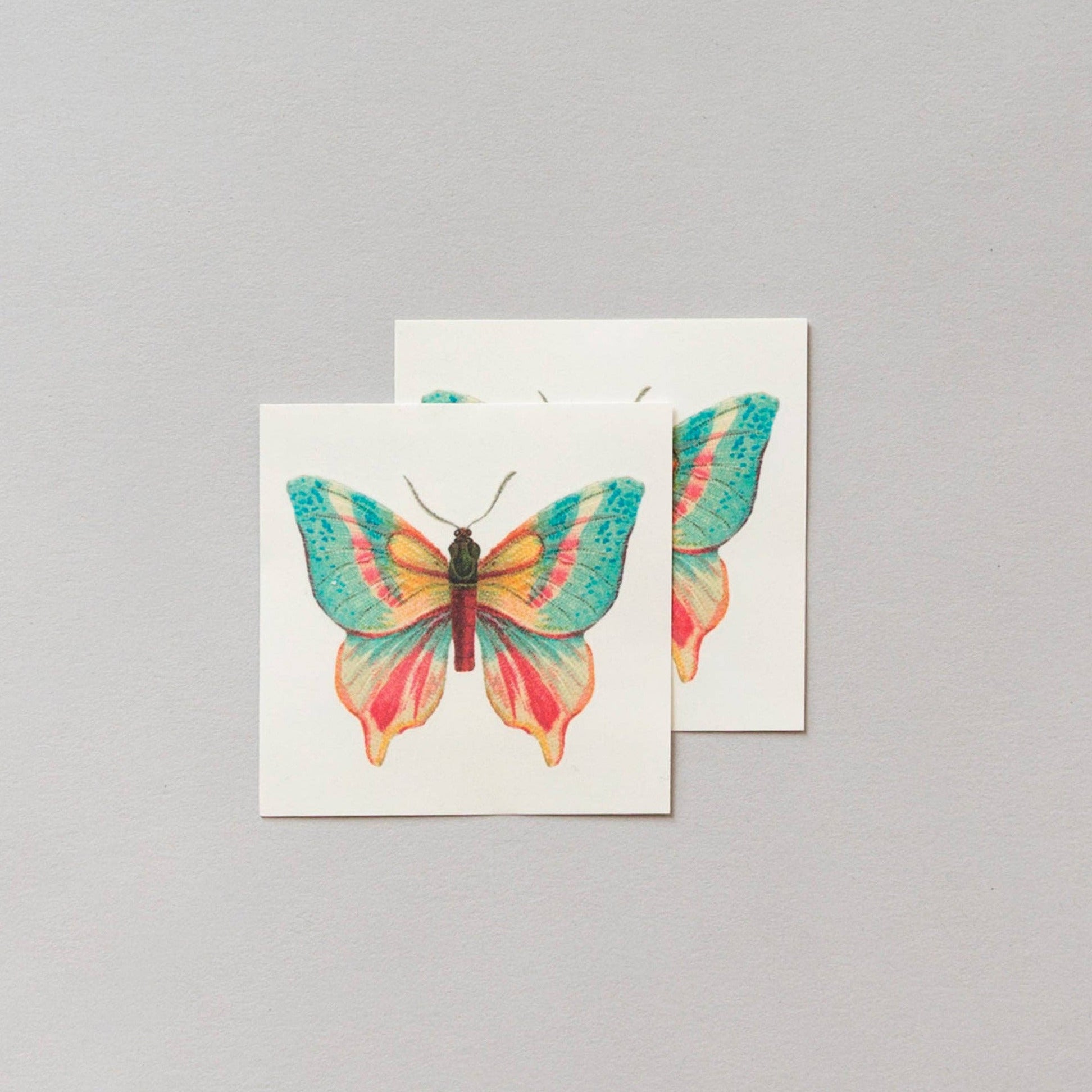 Two cards with colorful butterfly designs on a gray background