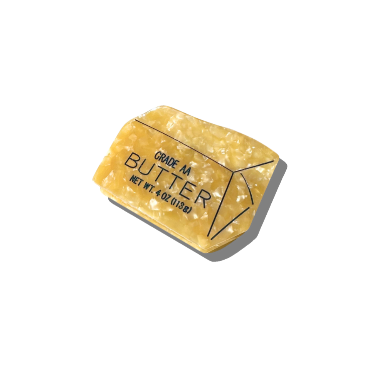 Block of butter with 'Grade A Butter' text on a white background