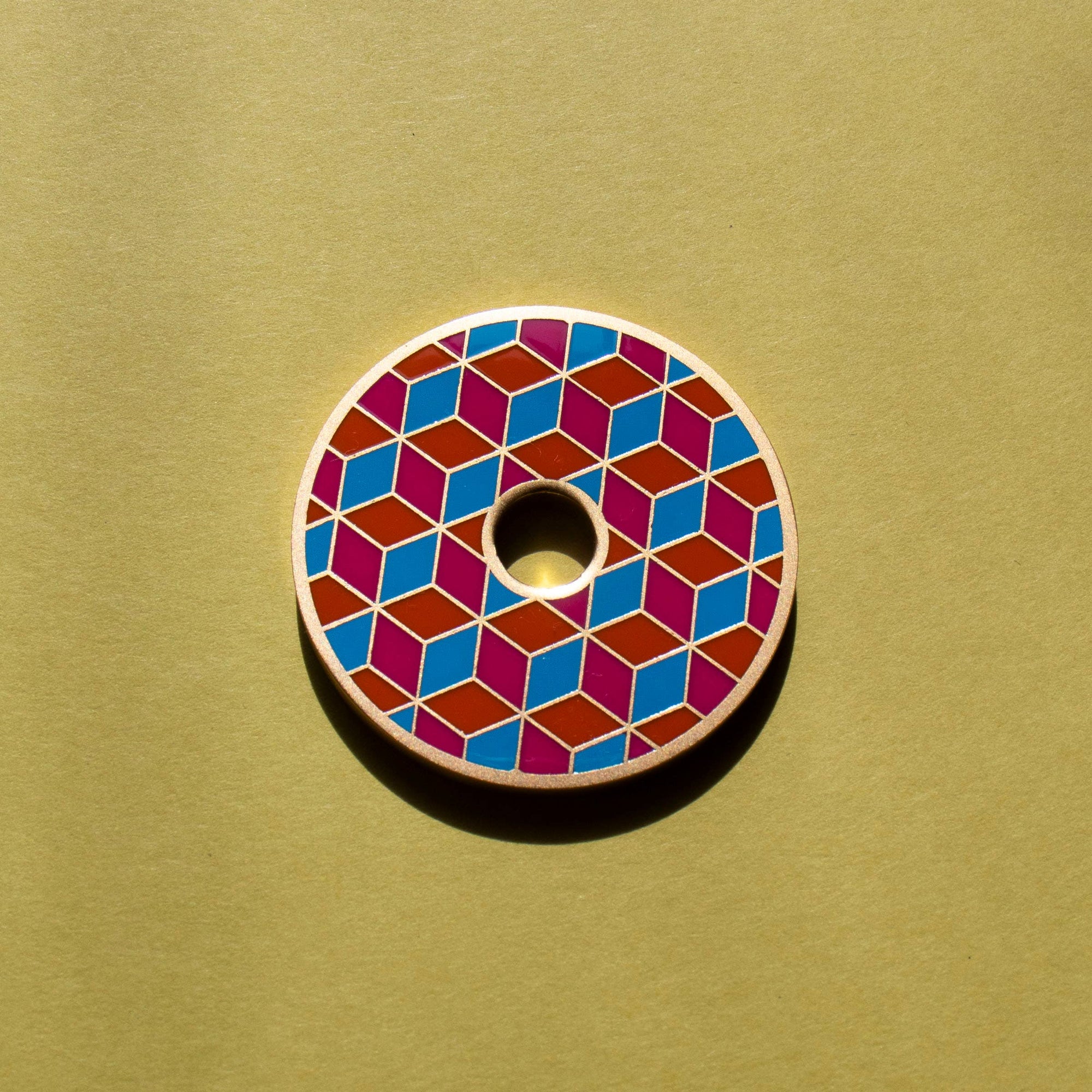 Colorful geometric patterned object on a beige background