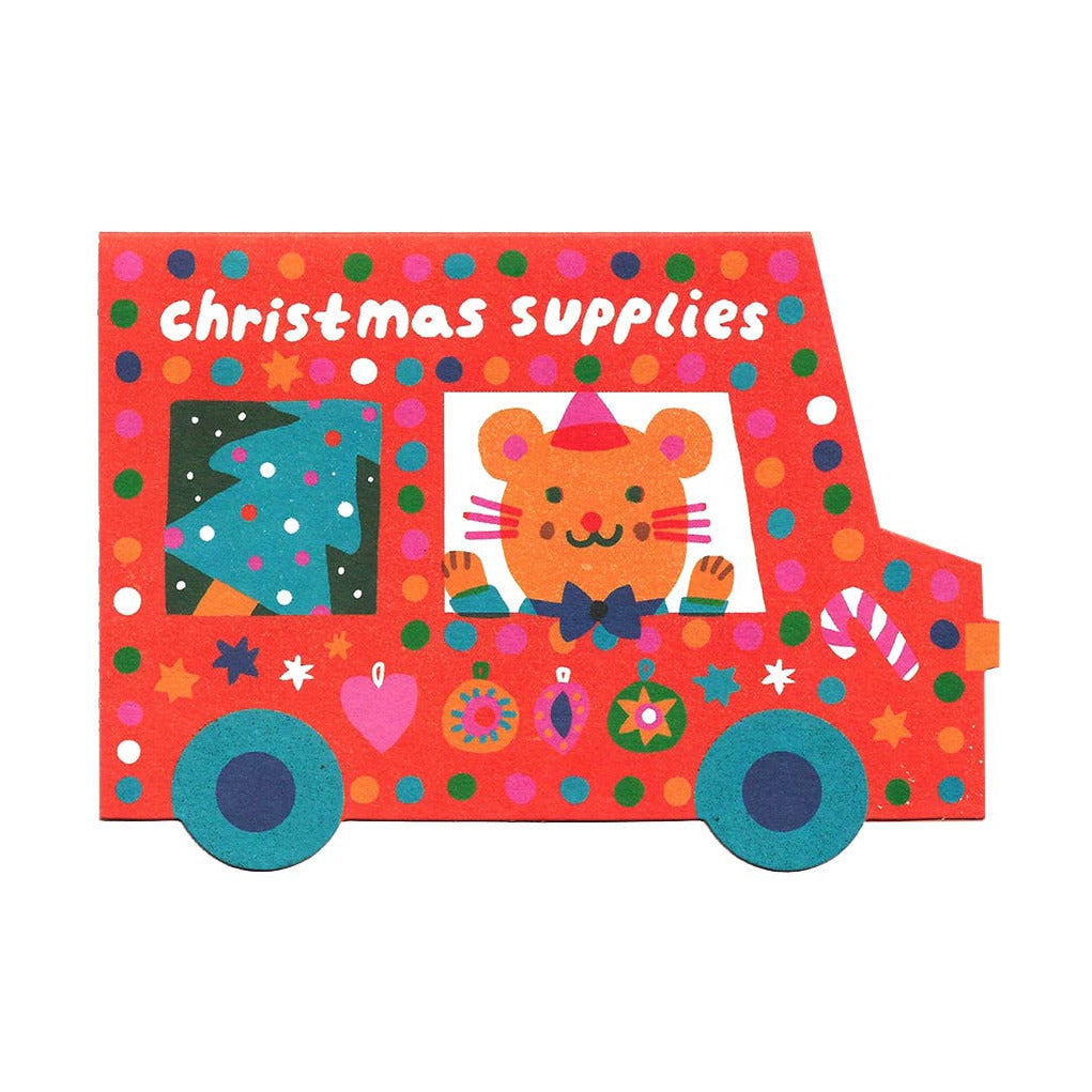 A colorful card shaped like a van with 'Christmas Supplies' written on it, decorated with festive patterns and a cartoon mouse driving the vehicle.