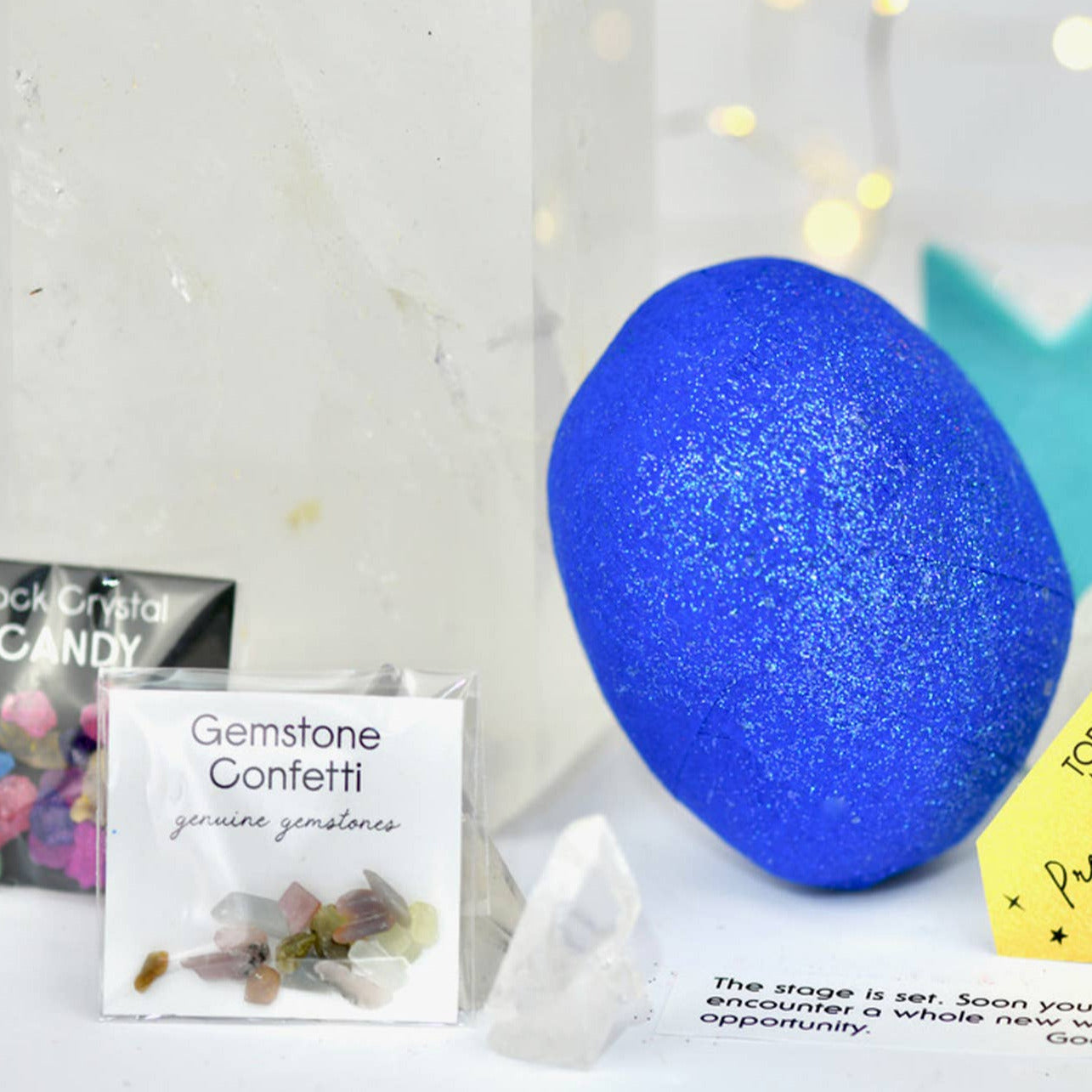Blue gemstone surprise ball with packaging and cards on a white background
