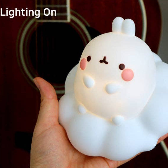 Cute white plush toy with a guitar in the background