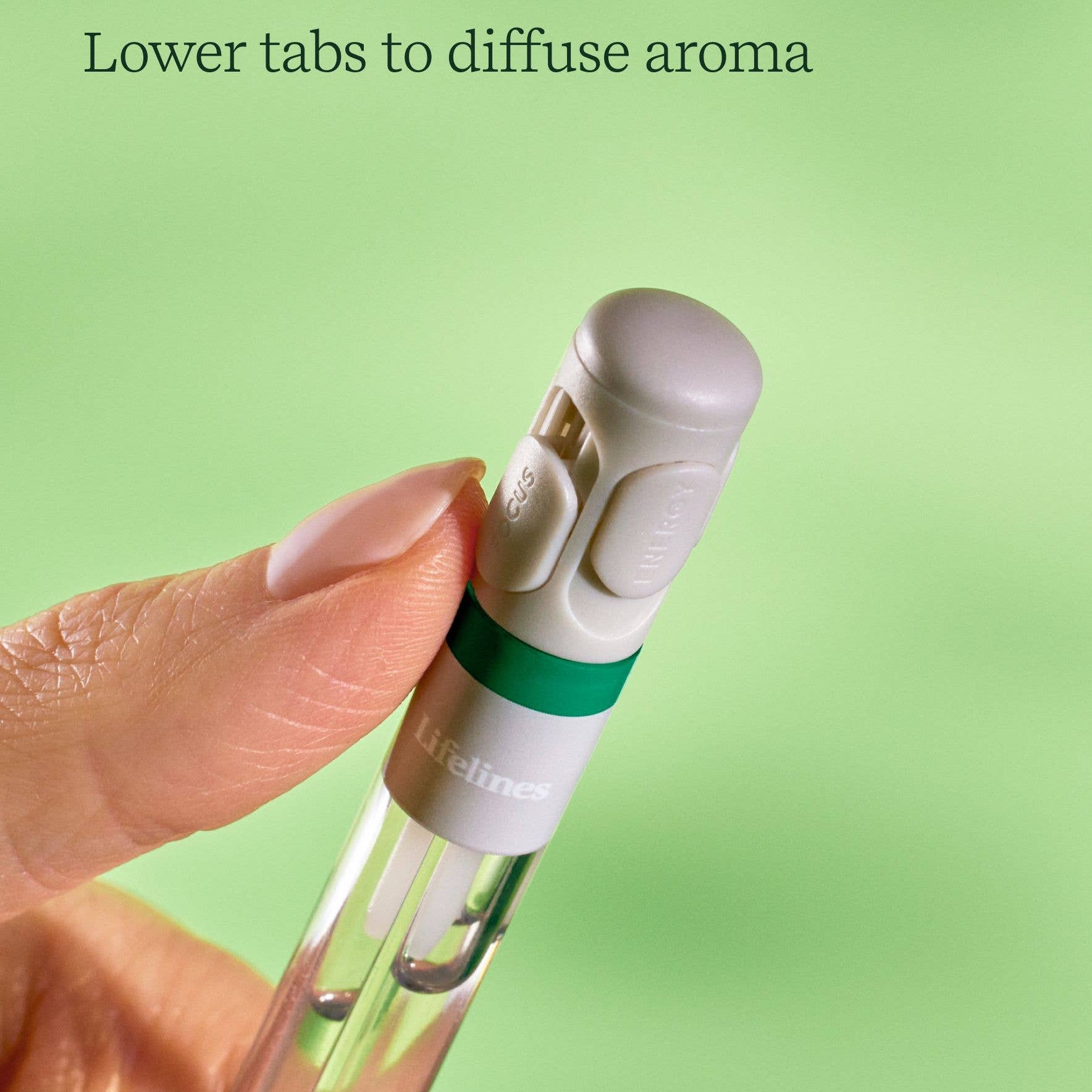 Hand holding a small device with a green background