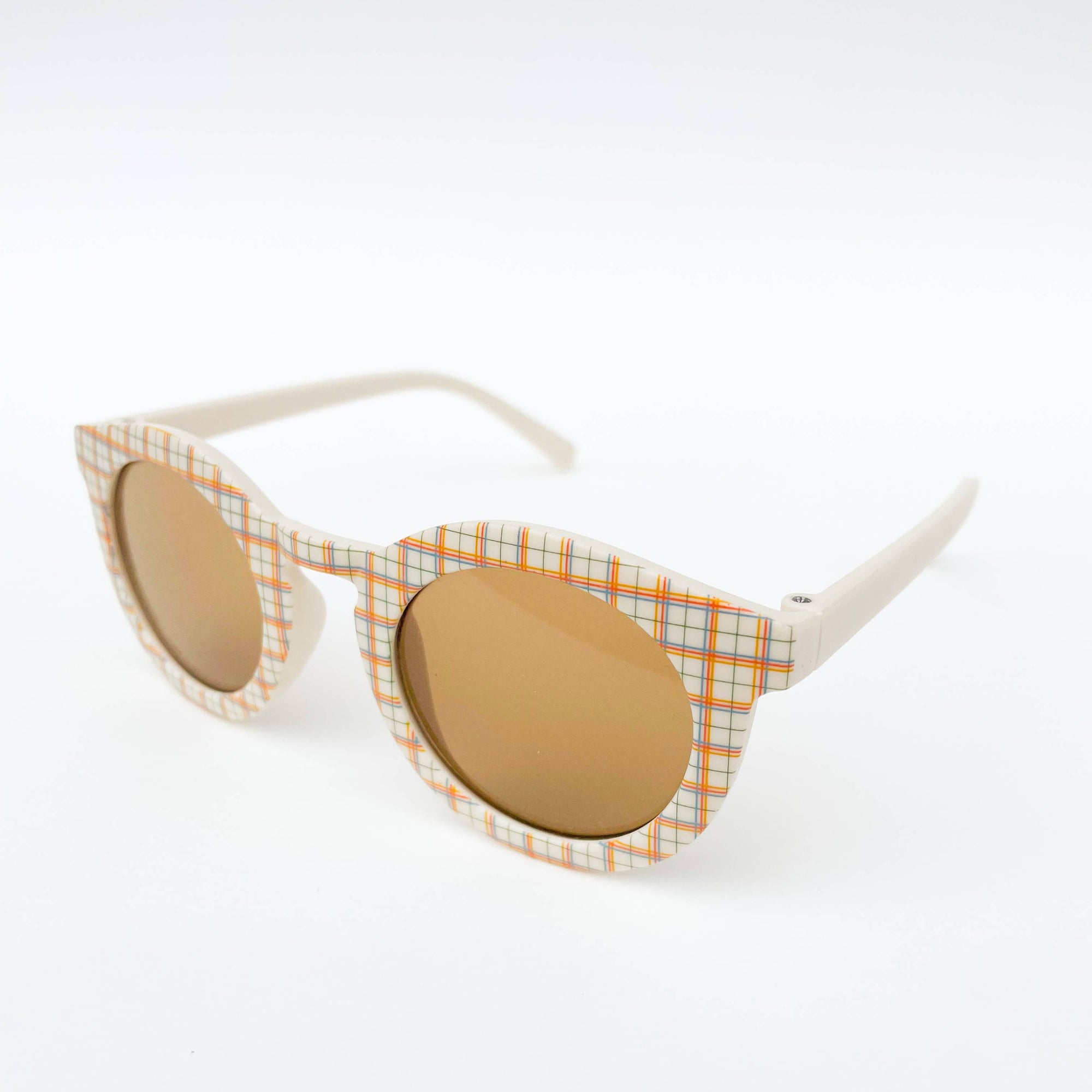 Sunglasses with checkered frame and round lenses on a white background