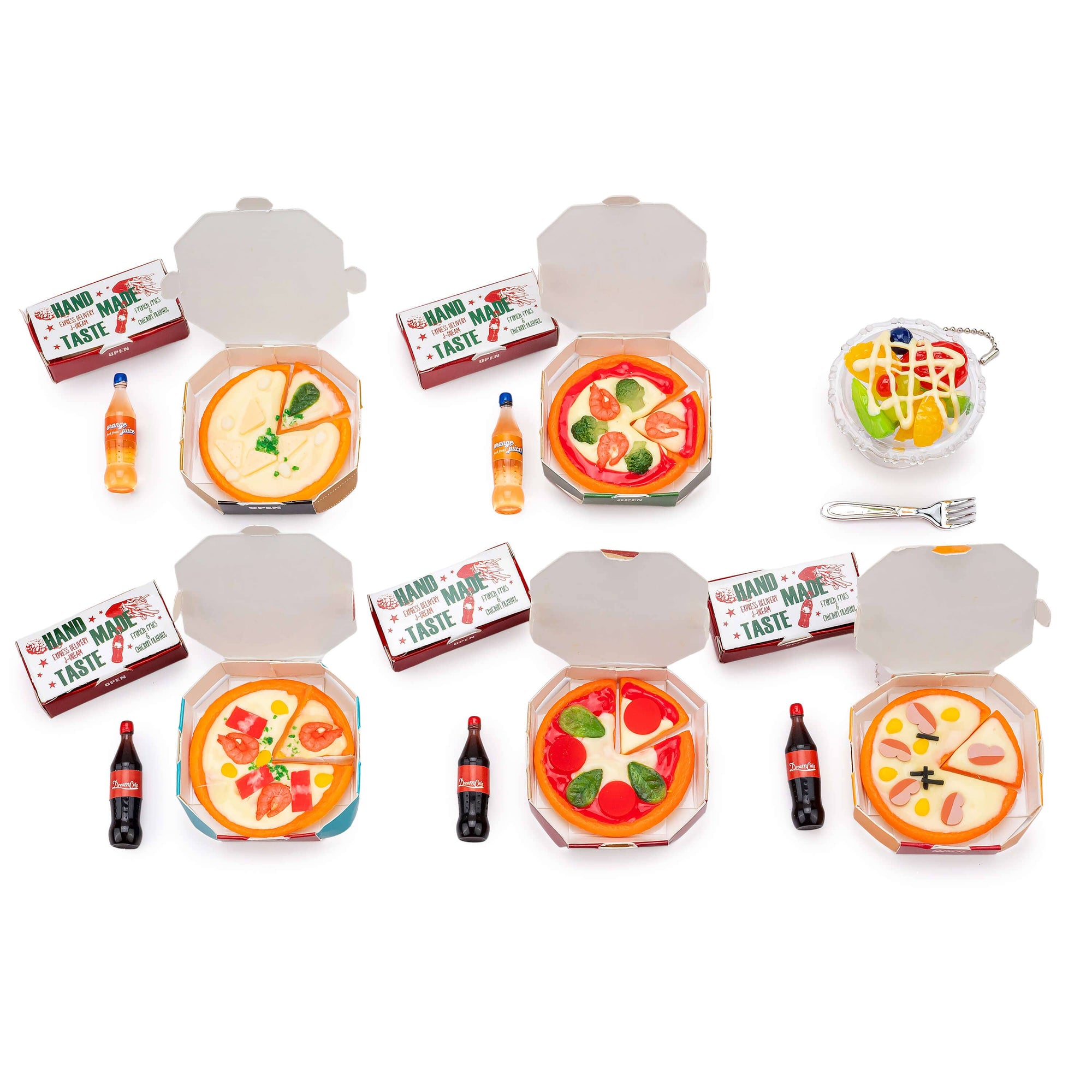Set of toy pizzas in boxes with drinks and utensils on a white background