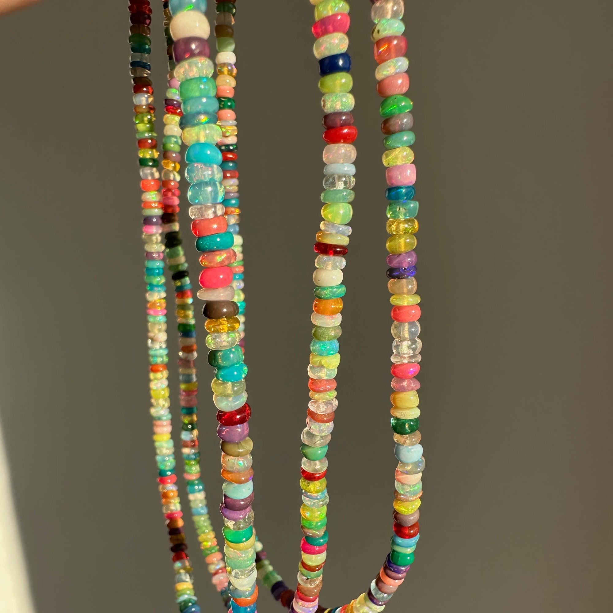 Colorful beaded necklaces on a plain background