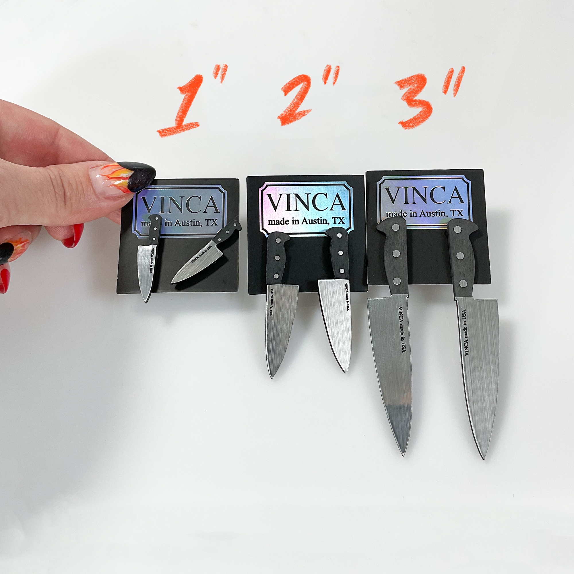 Set of knives on a holder with 'VINCA' branding, showing different blade sizes.