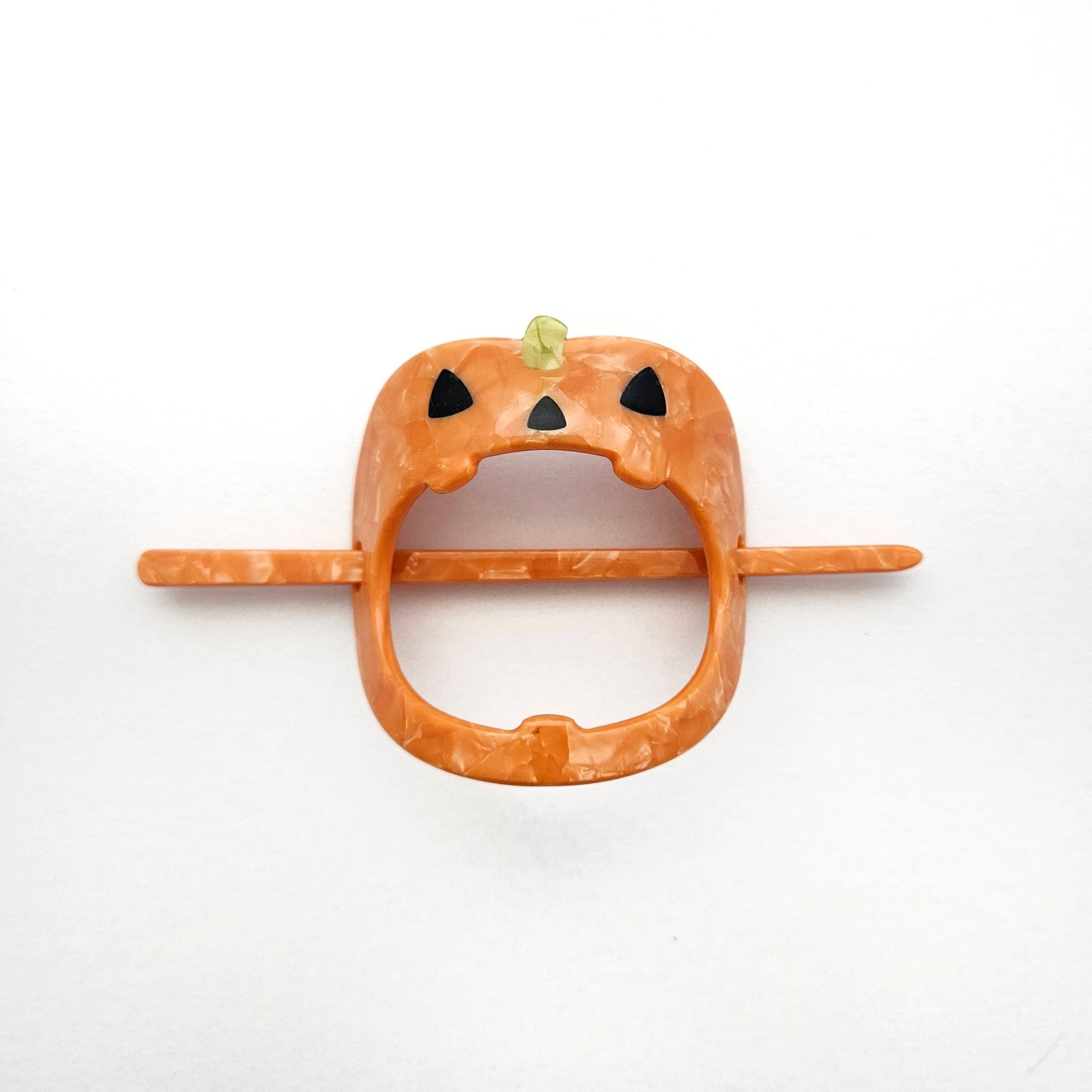 Pumpkin-shaped hair clip on a white background