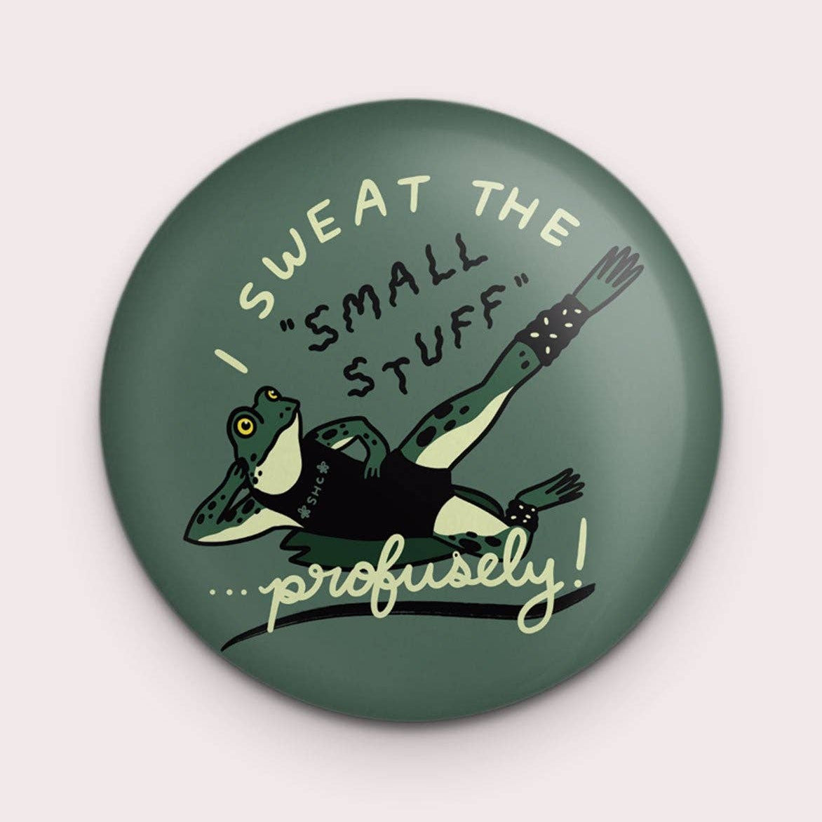 Button badge with a frog illustration and text on a green background