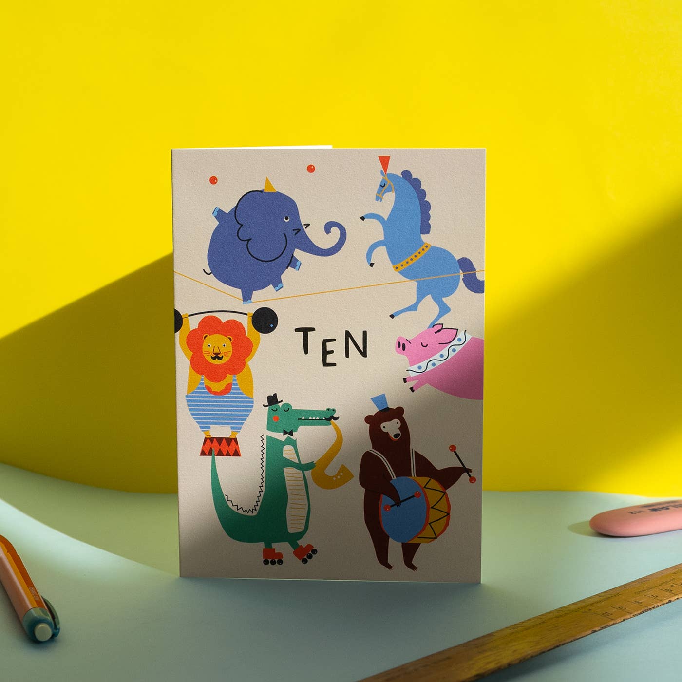 Card with animal illustrations and 'TEN' text on a yellow background