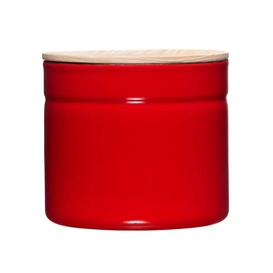 Red metal jar with a wooden lid on a white background