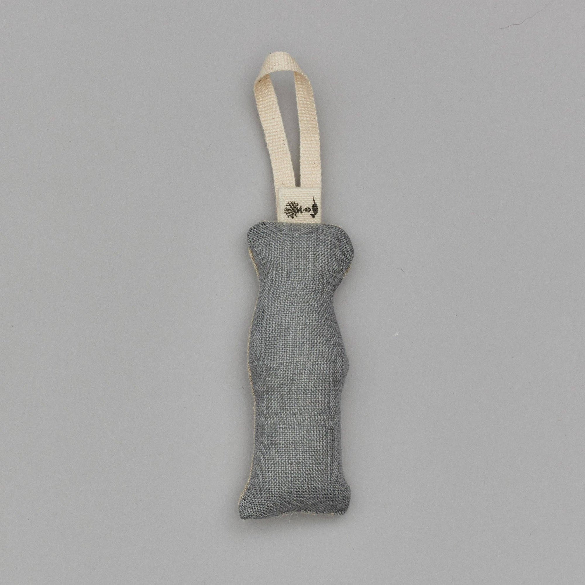 Gray textured ornament with a strap on a gray background