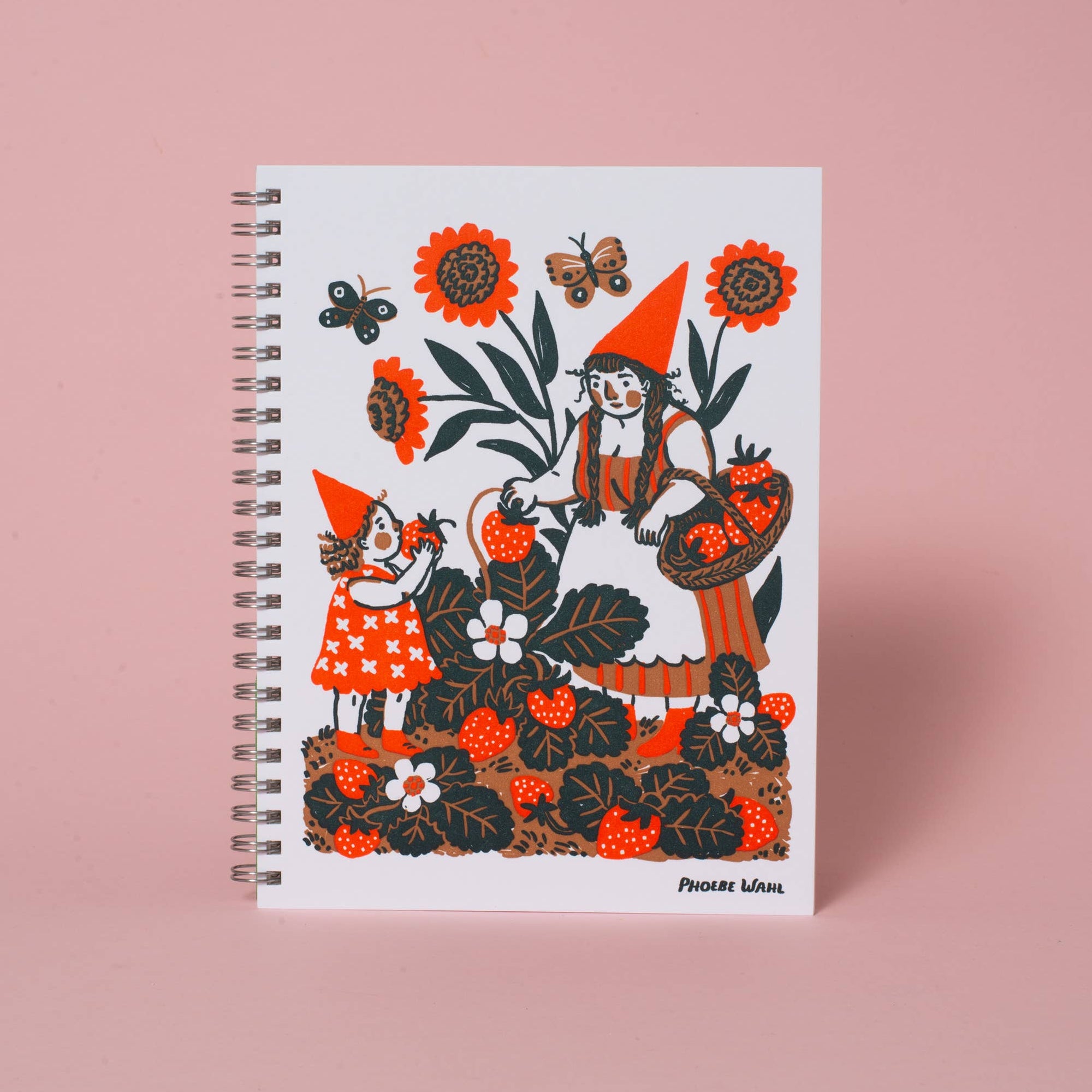 Notebook with a colorful illustration of a witch and a child on a pink background