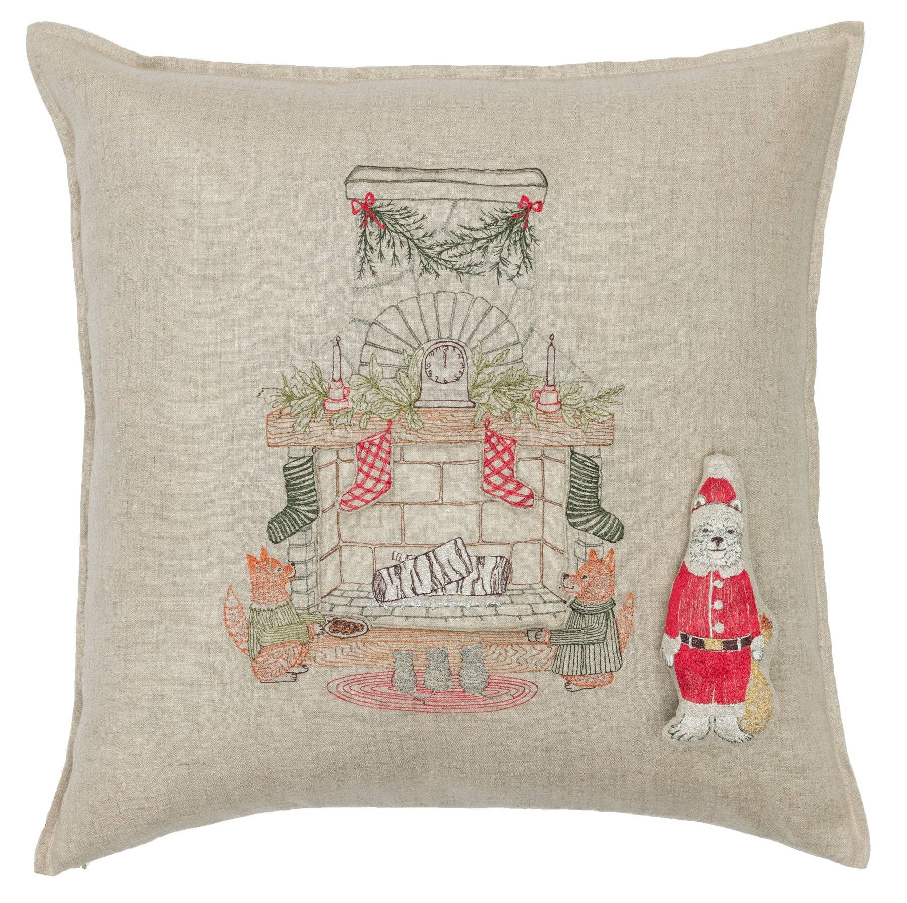 Decorative pillow with festive design featuring a fireplace, stockings, and Santa Claus.