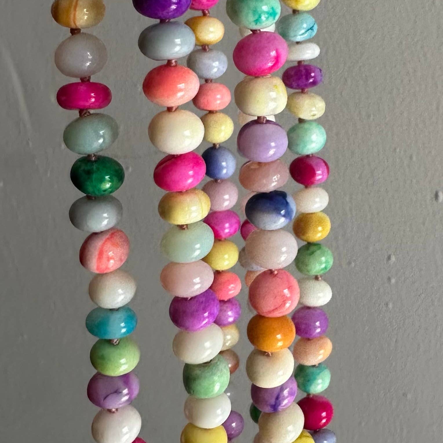 Colorful beaded necklace on a plain background