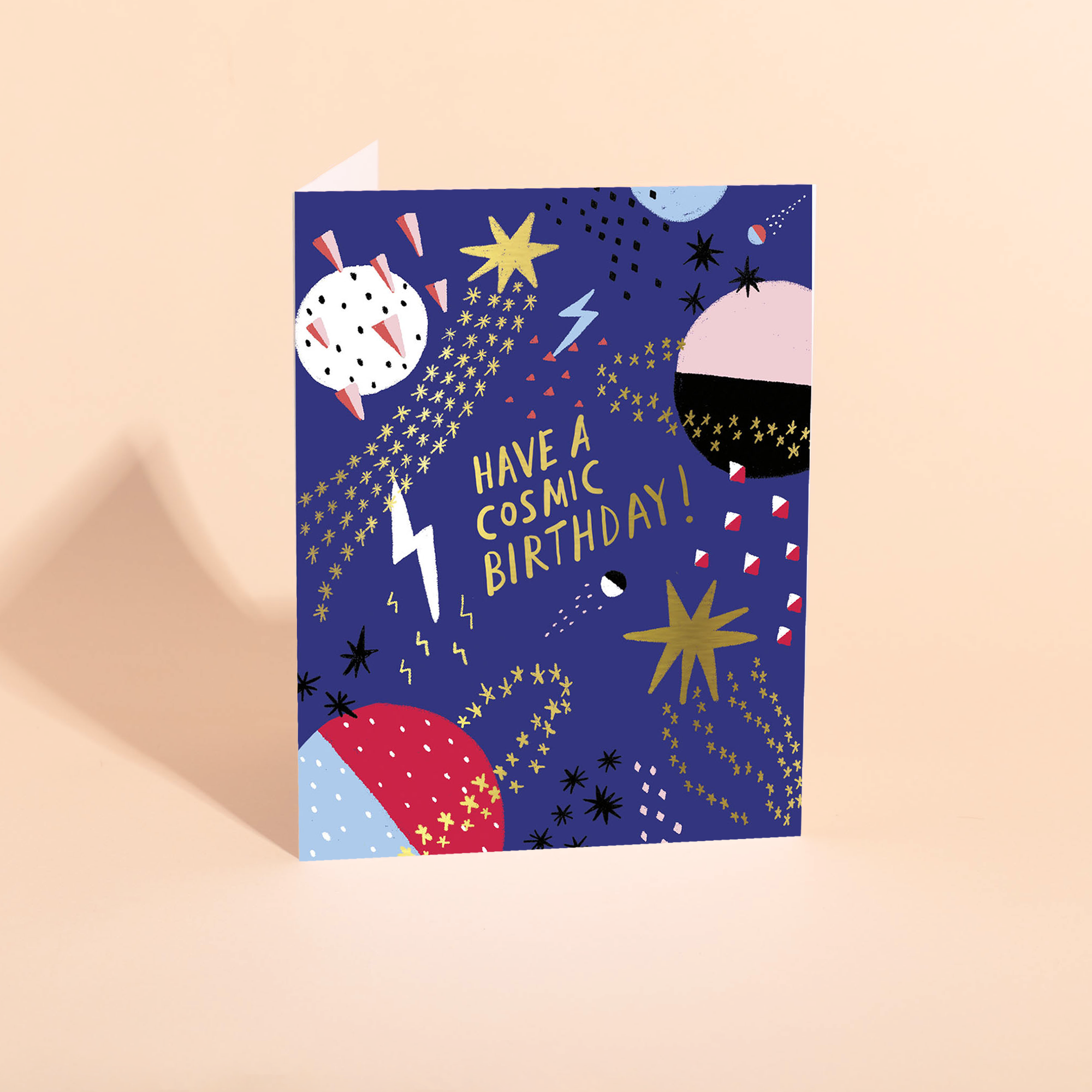 Greeting card with space-themed design and 'Have a cosmic birthday!' text on a beige background