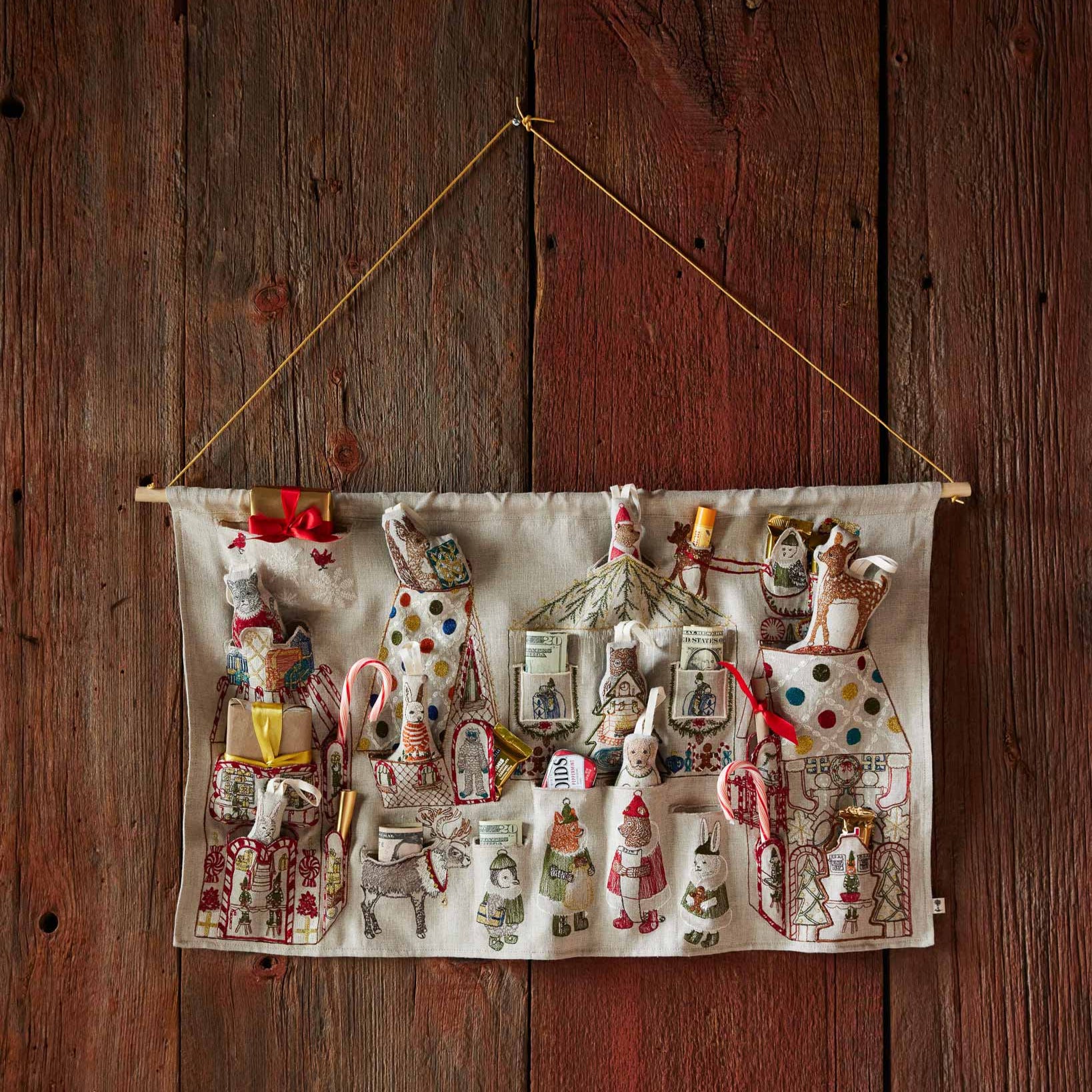 Decorative wall hanging with small figurines on a wooden background
