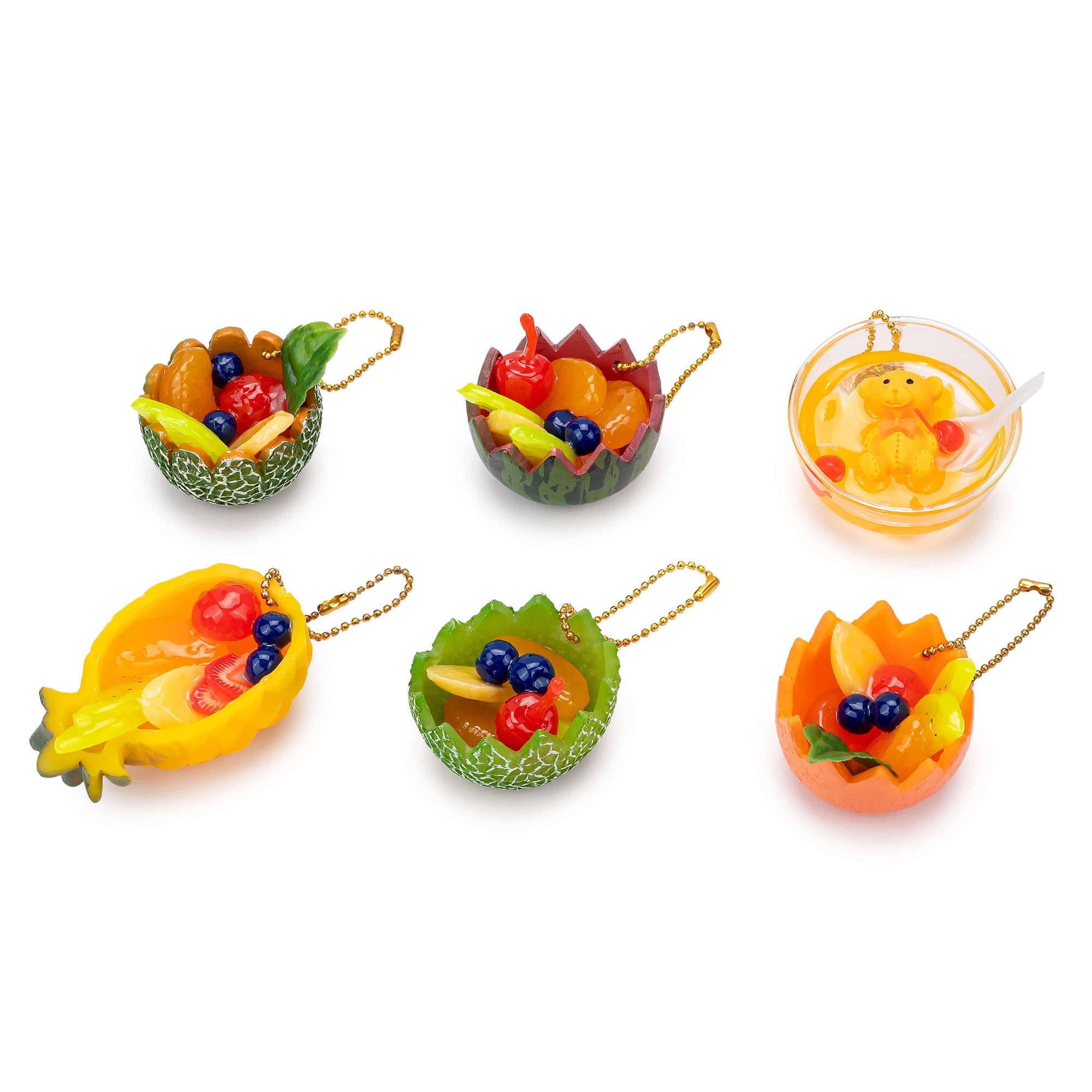 Set of fruit-shaped keychains on a white background