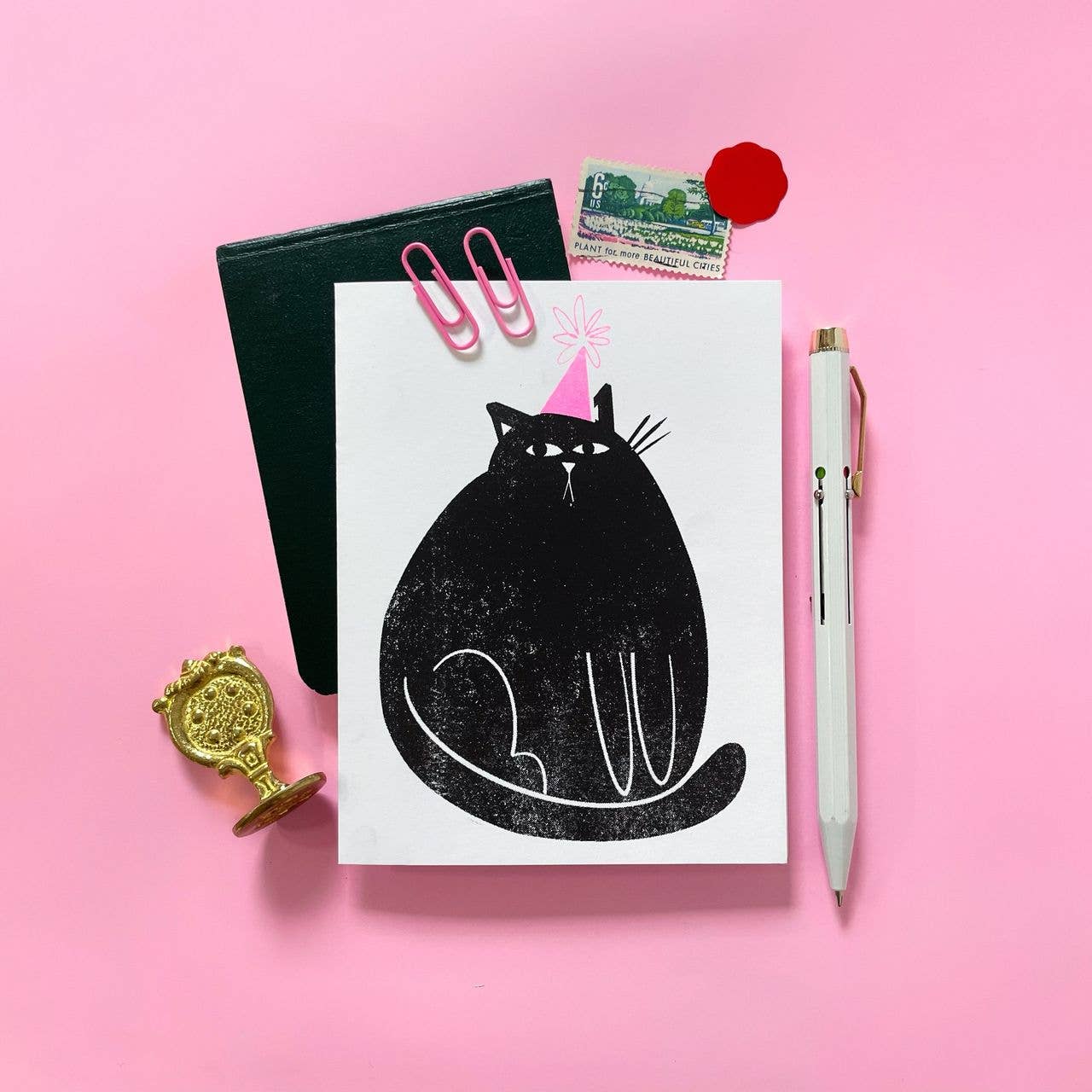 Greeting card with a black cat illustration on a pink background