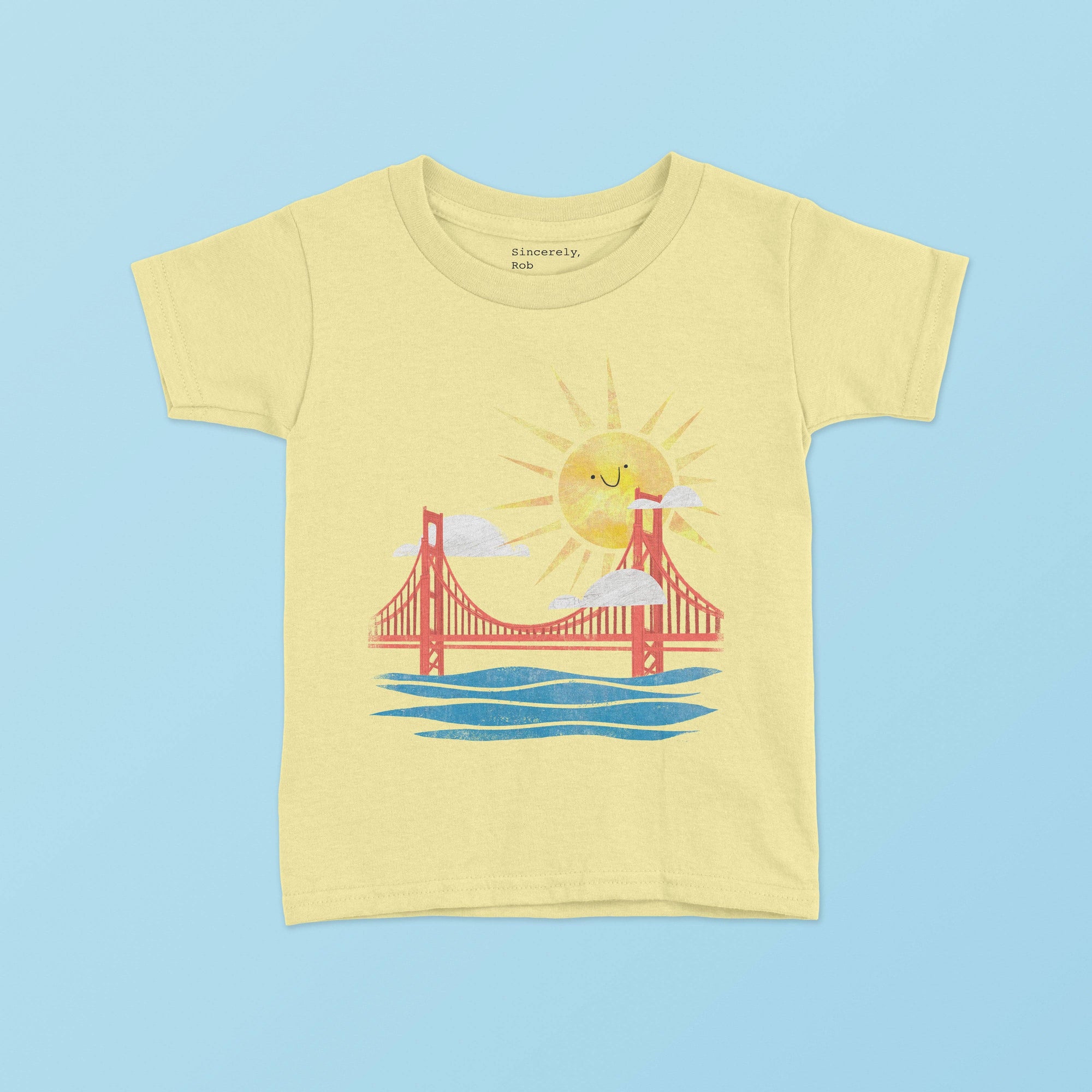 A yellow toddler t-shirt with a graphic of the Golden Gate Bridge and a sun design.