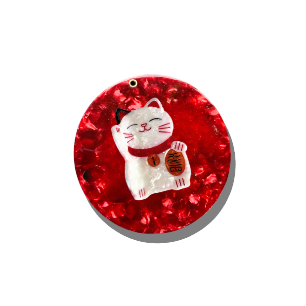 Decorative red ornament with a white cat design on a white background