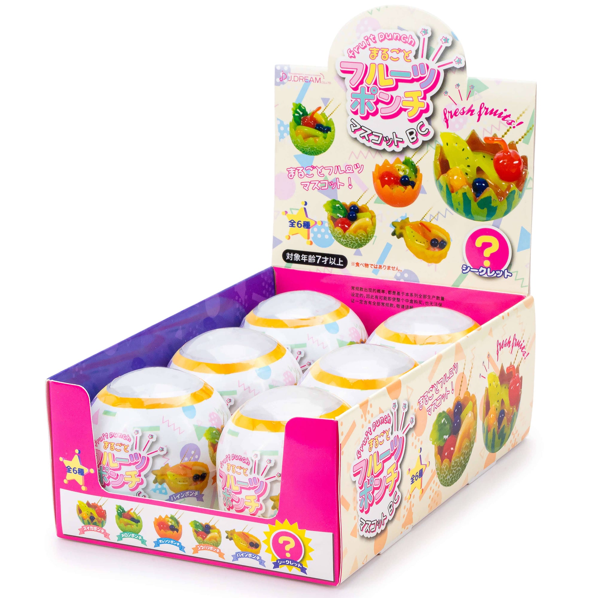 Display box of colorful gummy candy with fruit-themed packaging.