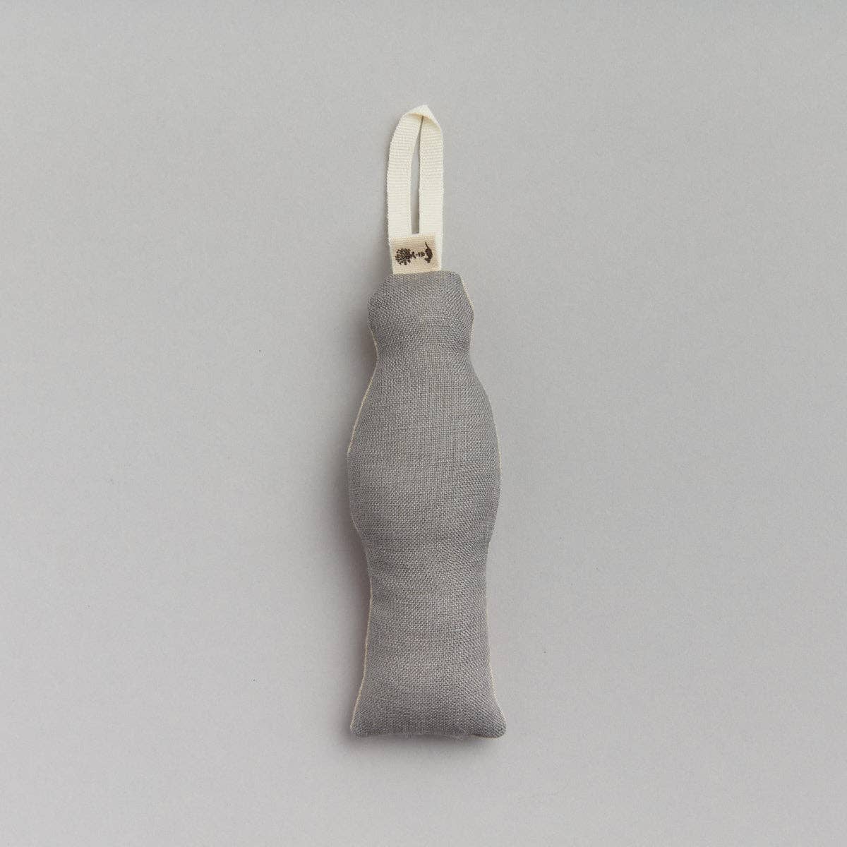 Gray fabric ornament with a white loop on a light gray background