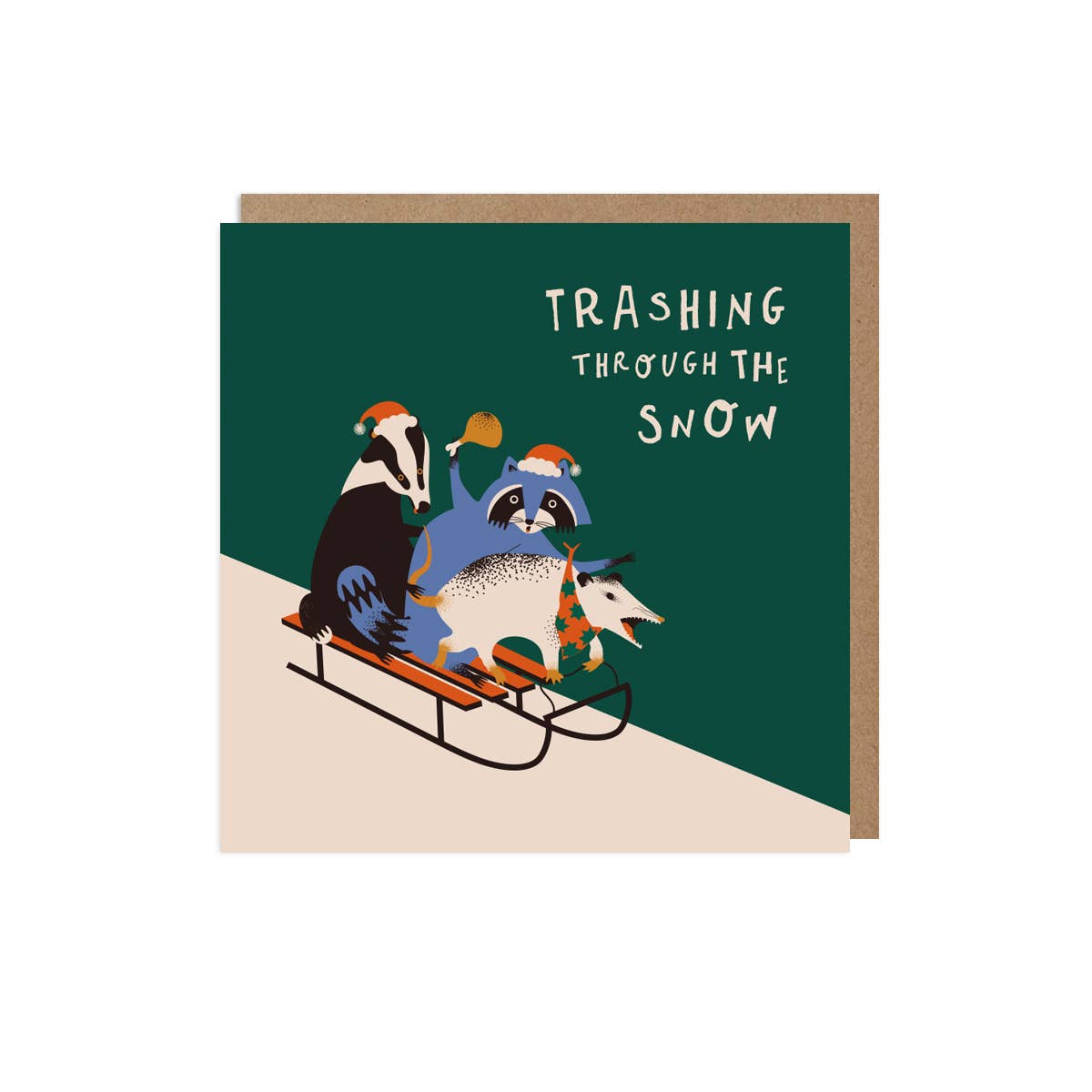 Card with illustration of animals sledding and text 'Trashing Through the Snow' on a green background.