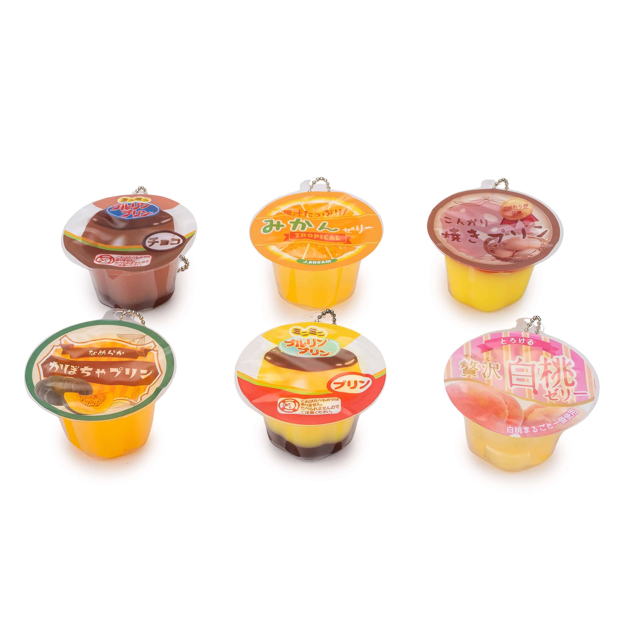 Set of six small dessert containers with colorful lids on a white background