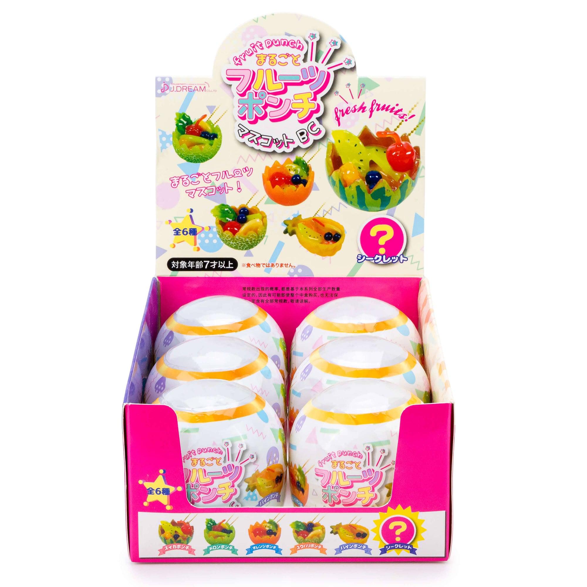 Display of fruit-shaped toy food in a colorful packaging with Japanese text.