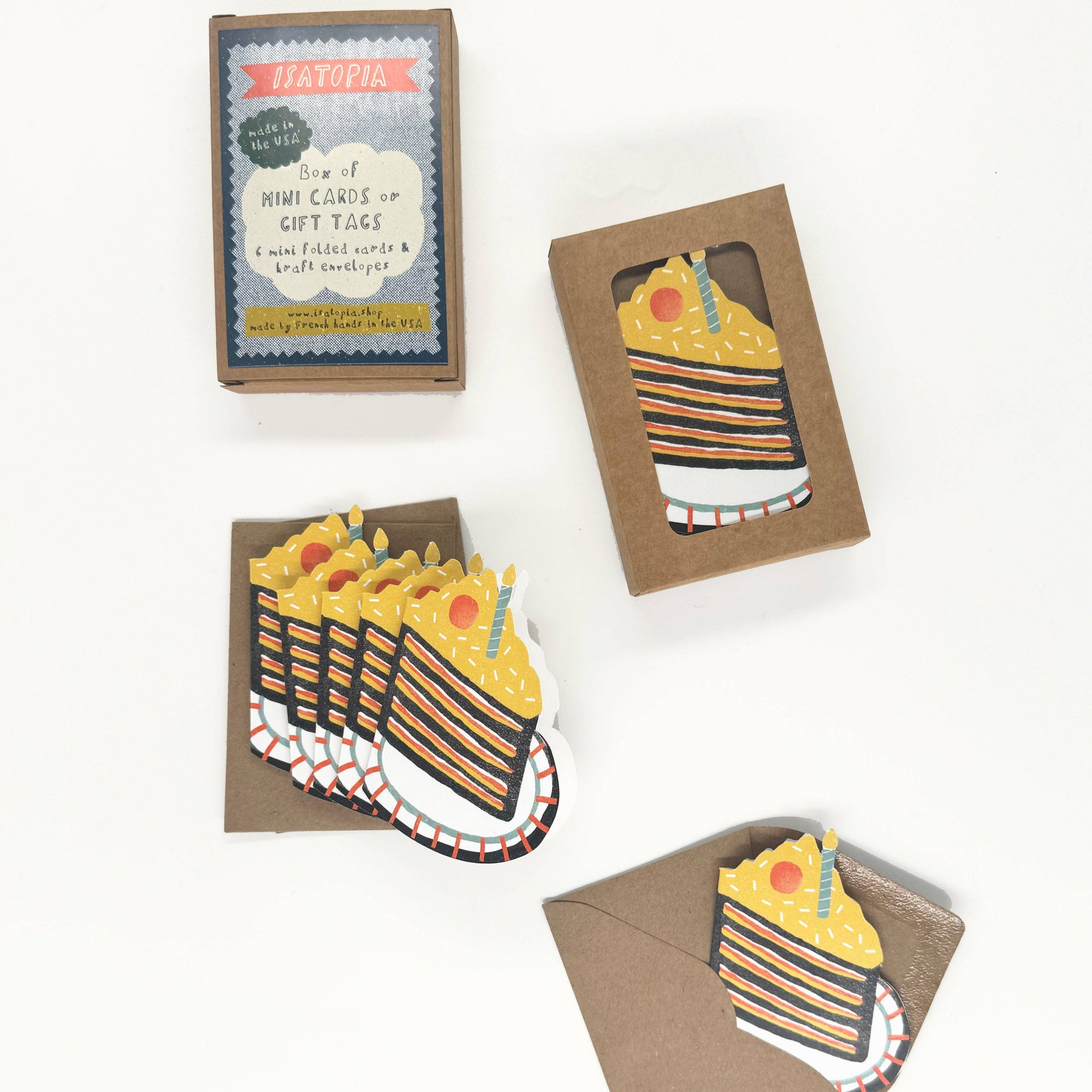 A set of mini birthday cards depicting a striped cake design, with envelopes and a box, all laid out on a white background.