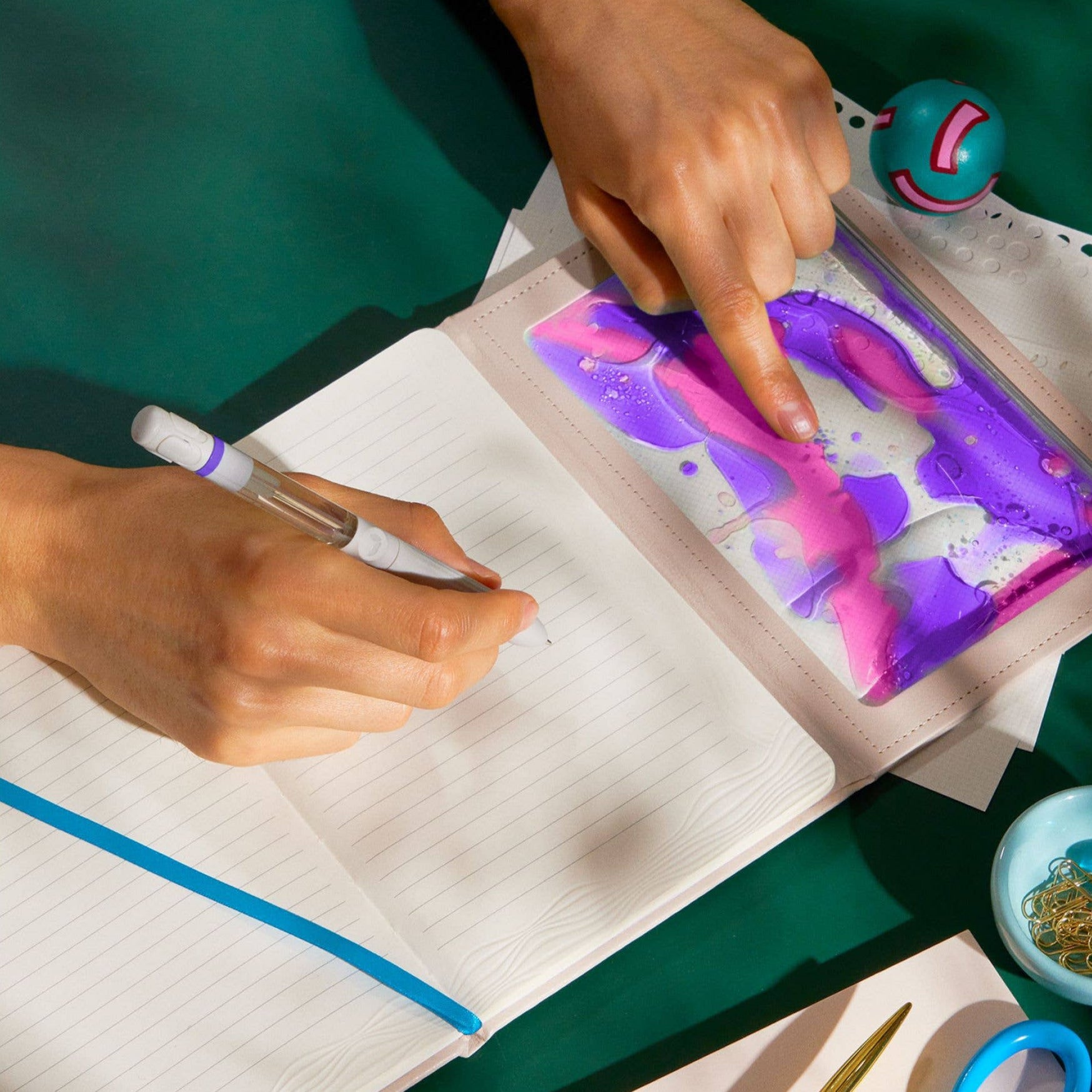 Person interacting with an interactive cover on a notebook